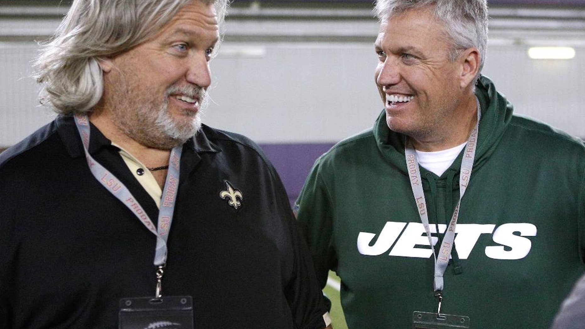 FILE - In this April 9, 2014, file photo, New Orleans Saints defensive coordinator Rob Ryan, left, and New York Jets head coach Rex Ryan talk to each other during NFL football pro day in Baton Rouge, La. The Ryan twins are best known for their defensive acumen. After four weeks, they are looking defenseless. Rex's Jets are 1-3, have lost three in a row and can't cover anyone in the passing game. Rob's Saints, he's the defensive coordinator under coach Sean Payton, have been even worse than Rex's bunch. (AP Photo/Jonathan Bachman, File)