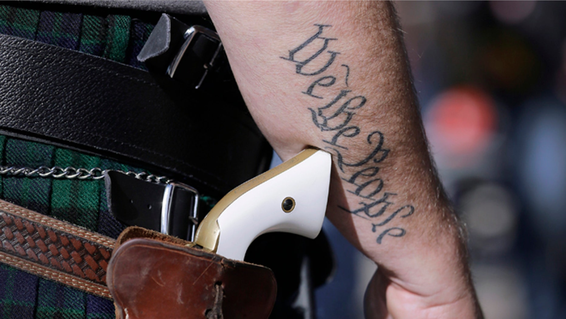 FILE - In this Jan. 26, 2015, file photo, Scott Smith, a supporter of open carry gun laws, wears a pistol as he prepares for a rally in support of open carry gun laws at the Capitol, in Austin, Texas. Despite its reputation as the trigger-happy heart of American gun culture, Texas is late to the open carry party, at least when it comes to handguns. On New Yearâs Day, itâll become the 45th state to legalize carrying a pistol in plain sight. (AP Photo/Eric Gay, File)