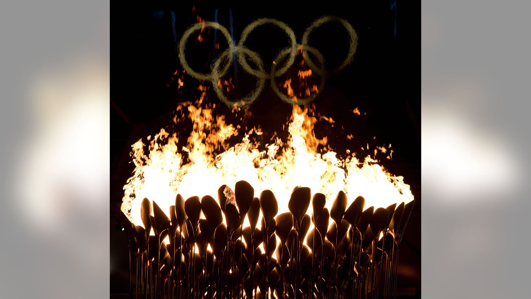 The Olympic cauldron burns following the opening ceremonies to the 2012 Summer Olympics in London on Saturday, July 28, 2012. (AP Photo/The Canadian Press, Sean Kilpatrick)