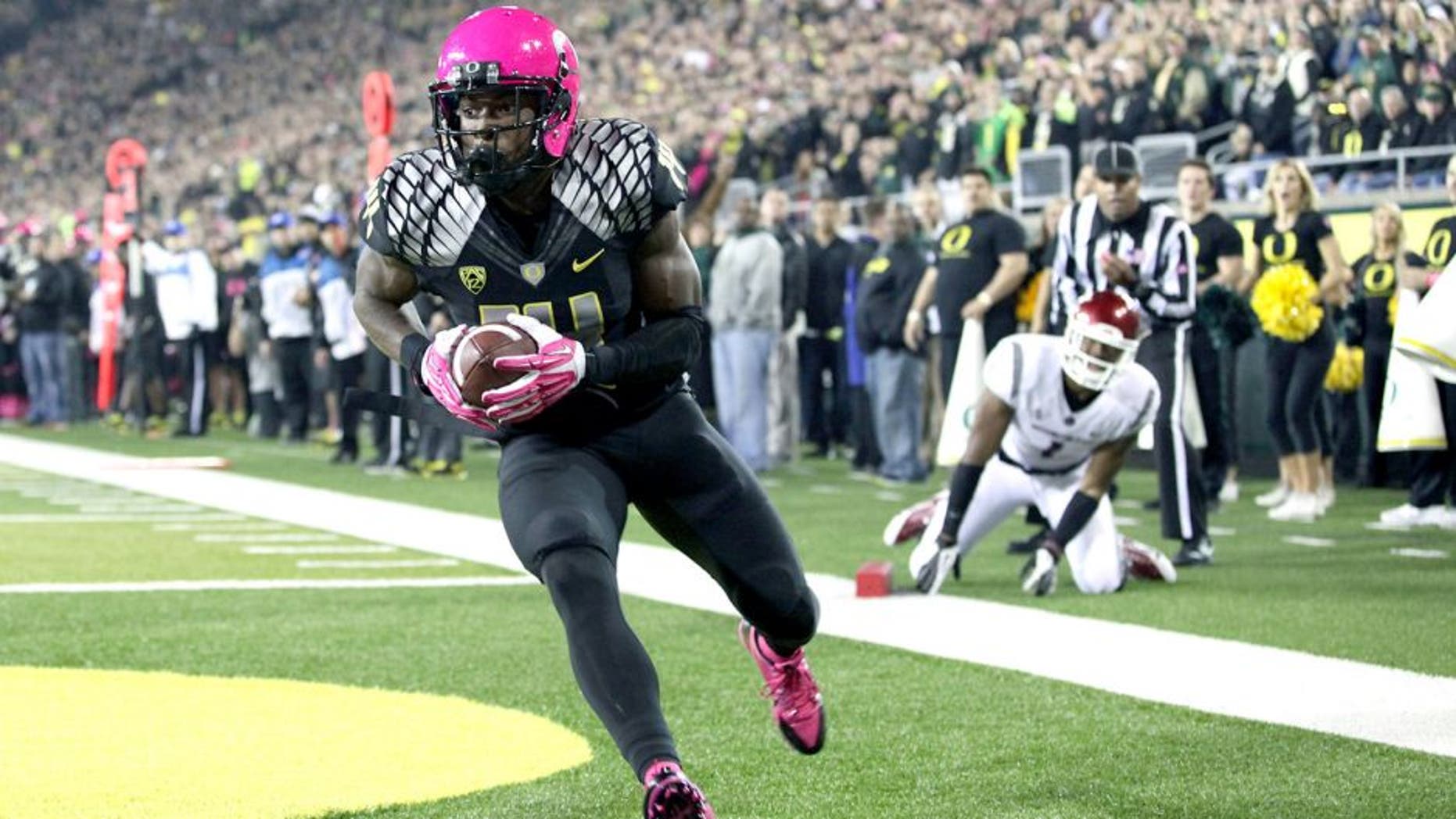 Oct 19, 2013; Eugene, OR, USA; Oregon Ducks cornerback Ifo Ekpre-Olomu (14) catches the ball for a touch back against the Washington State Cougars at Autzen Stadium. Mandatory Credit: Scott Olmos-USA TODAY Sports