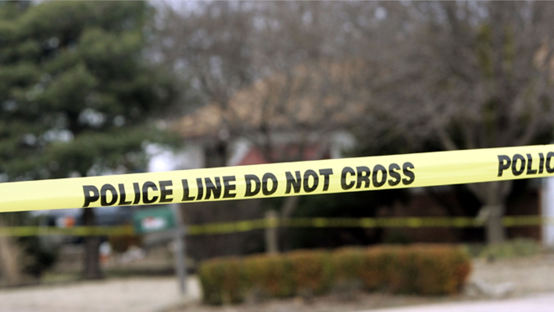 PARK CITY, KS - FEBUARY 26: Police tape hangs across the street in front of the house that Dennis Rader lives in February 26, 2005 in Park City, Kansas. Rader is the suspect whom police have arrested on suspicion of first-degree murder in connection with the 10 deaths now tied to the serial killer known as BTK. (Photo by Larry W. Smith/Getty Images)