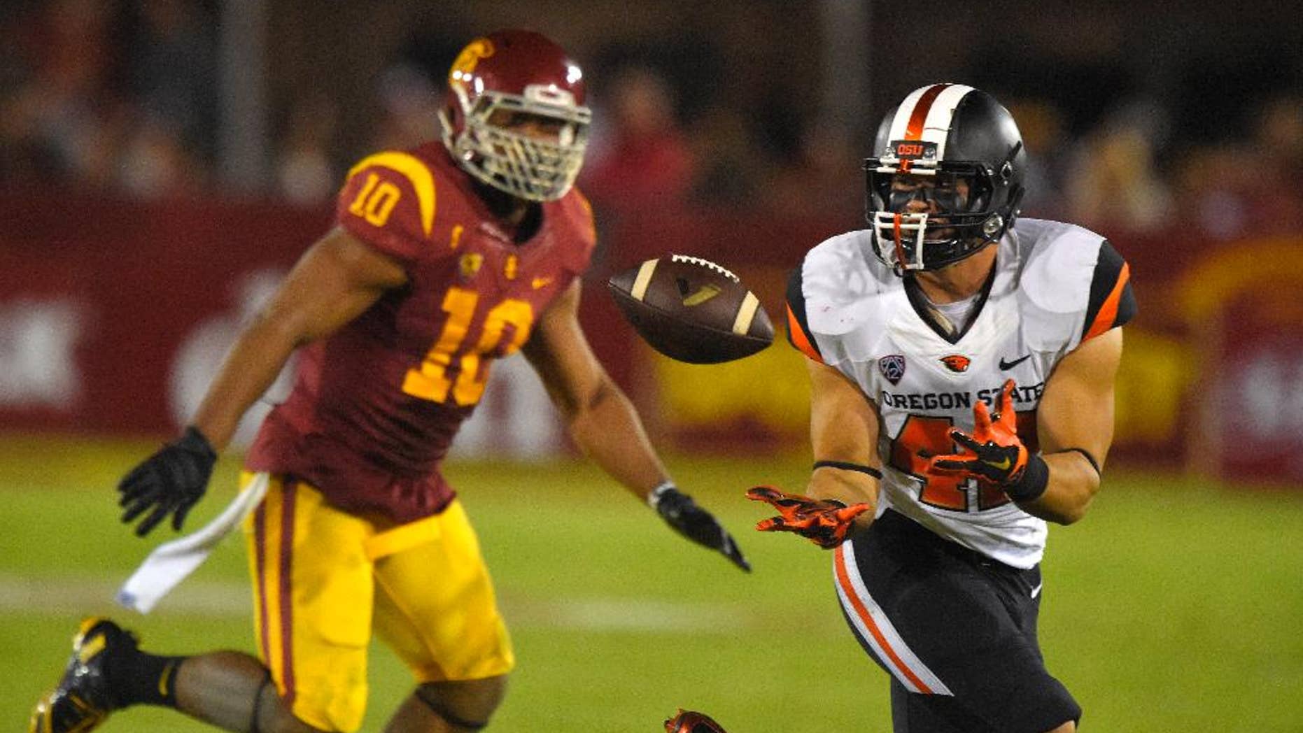 Oregon State fullback Ricky Ortiz, right, makes a catch as Southern California linebacker Hayes Pullard defends during the second half of an NCAA college football game, Saturday, Sept. 27, 2014, in Los Angeles. USC won the game 35-10. (AP Photo/Mark J. Terrill)