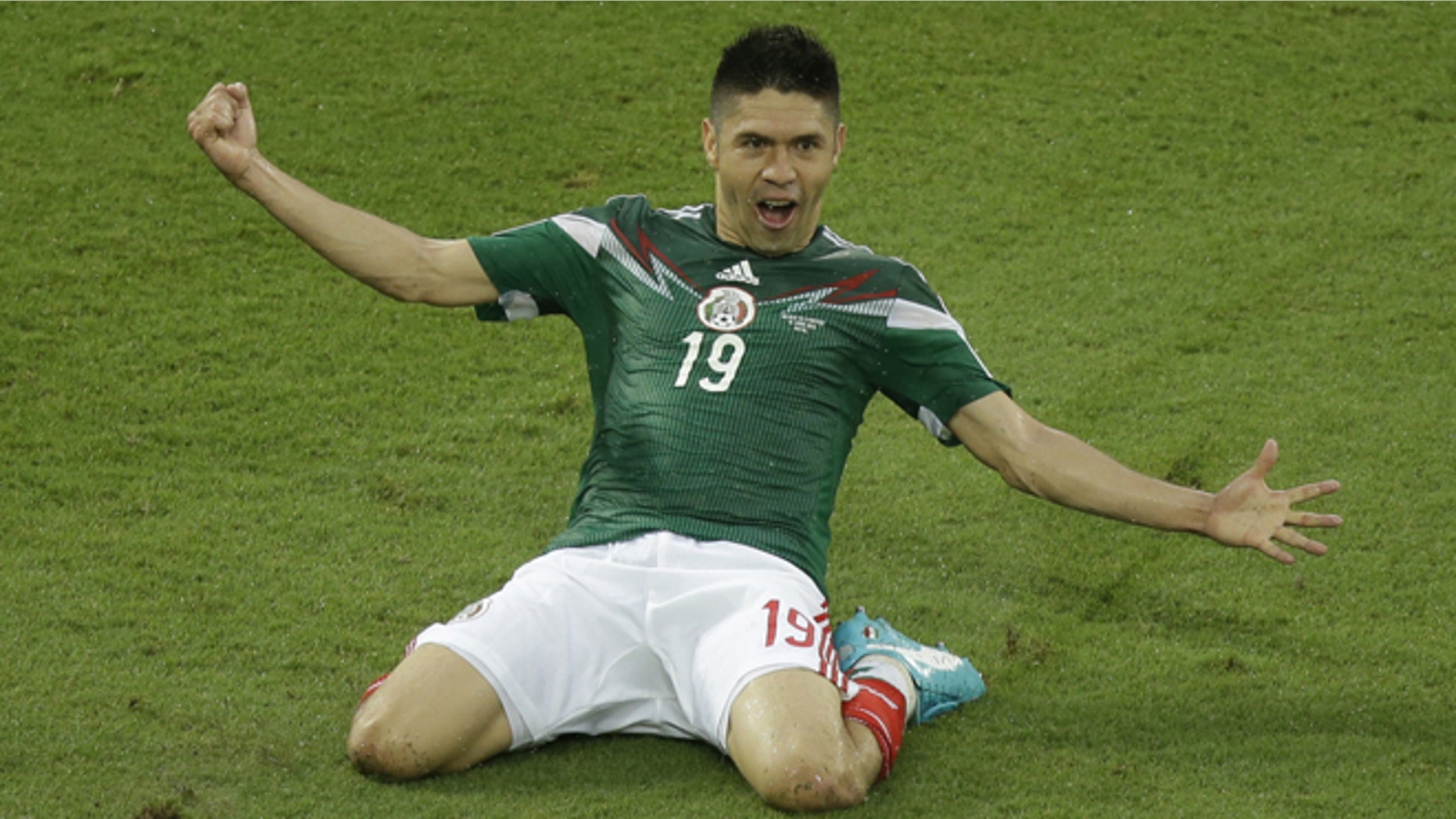Mexico's Oribe Peralta celebrates after scoring during the group A World Cup soccer match between Mexico and Cameroon in the Arena das Dunas in Natal, Brazil, Friday, June 13, 2014. (AP Photo/Hassan Ammar)