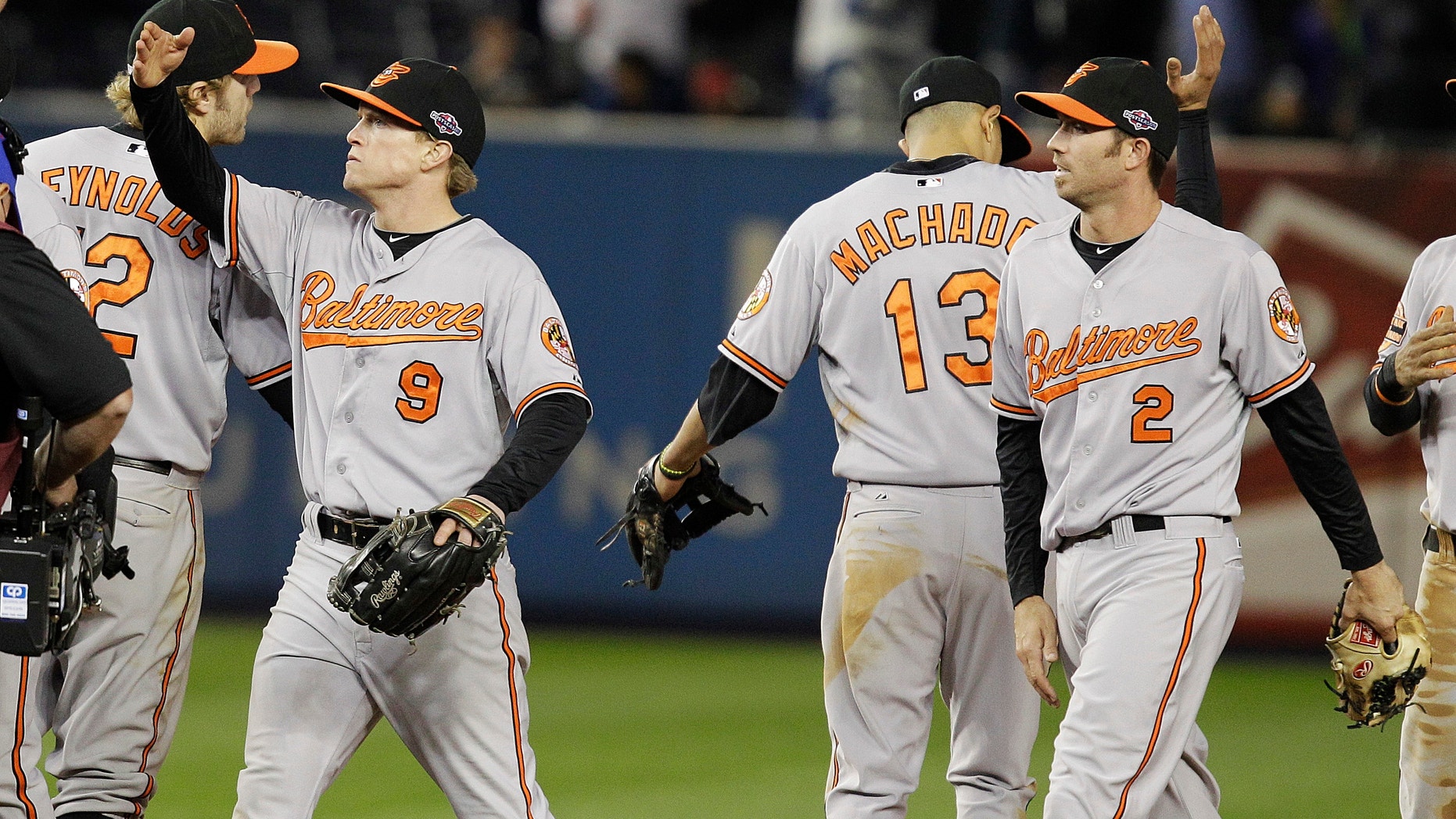 Oct. 11, 2012: Baltimore Orioles' Nate McLouth (9) and J.J. Hardy (2) celebrate with teammates after Game 4 of the American League division baseball series against the New York Yankees late Thursday.