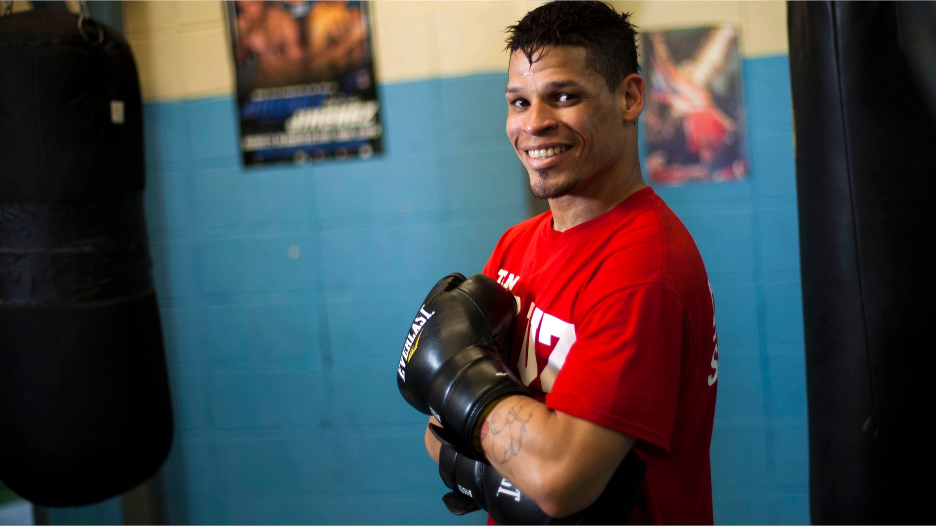 Boxer Orlando Cruz poses for pictures after a training session at a public gym in San Juan, Puerto Rico, Oct. 4, 2012.