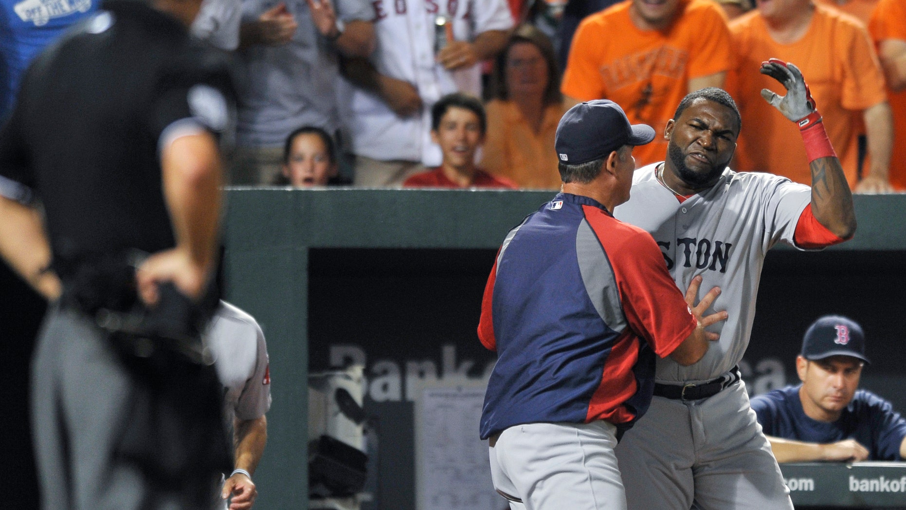 Boston Red Sox designated hitter David Ortiz reacts and is held back by manager John Farrell after being ejected by home plate umpire Tim Timmons for arguing a called third strike in the seventh inning of a baseball game against the Baltimore Orioles, Saturday, July 27, 2013, in Baltimore. Boston won 7-3. (AP Photo/Gail Burton)