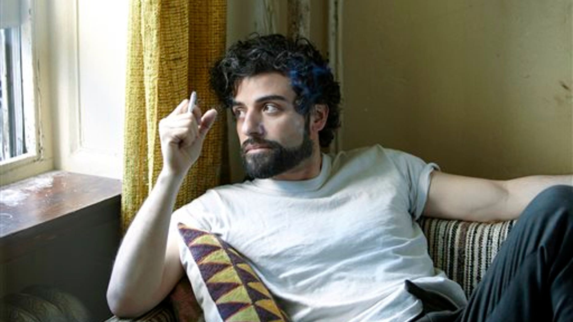 This film image released by CBS FIlms shows Oscar Isaac in a scene from "Inside Llewyn Davis." Isaac was nominated for a Golden Globe for best actor in a motion picture musical or comedy for his role in the film on Thursday, Dec. 12, 2013. The 71st annual Golden Globes will air on Sunday, Jan. 12. (AP Photo/CBS FIlms, Alison Rosa)