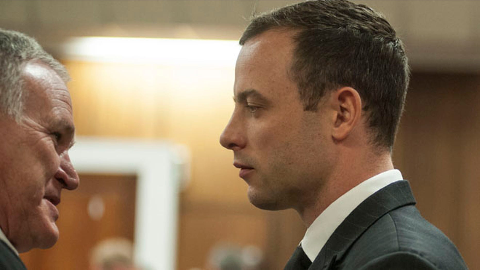 June 30, 2014: Oscar Pistorius listens to his lawyer Barry Roux, left, in court in Pretoria, South Africa.