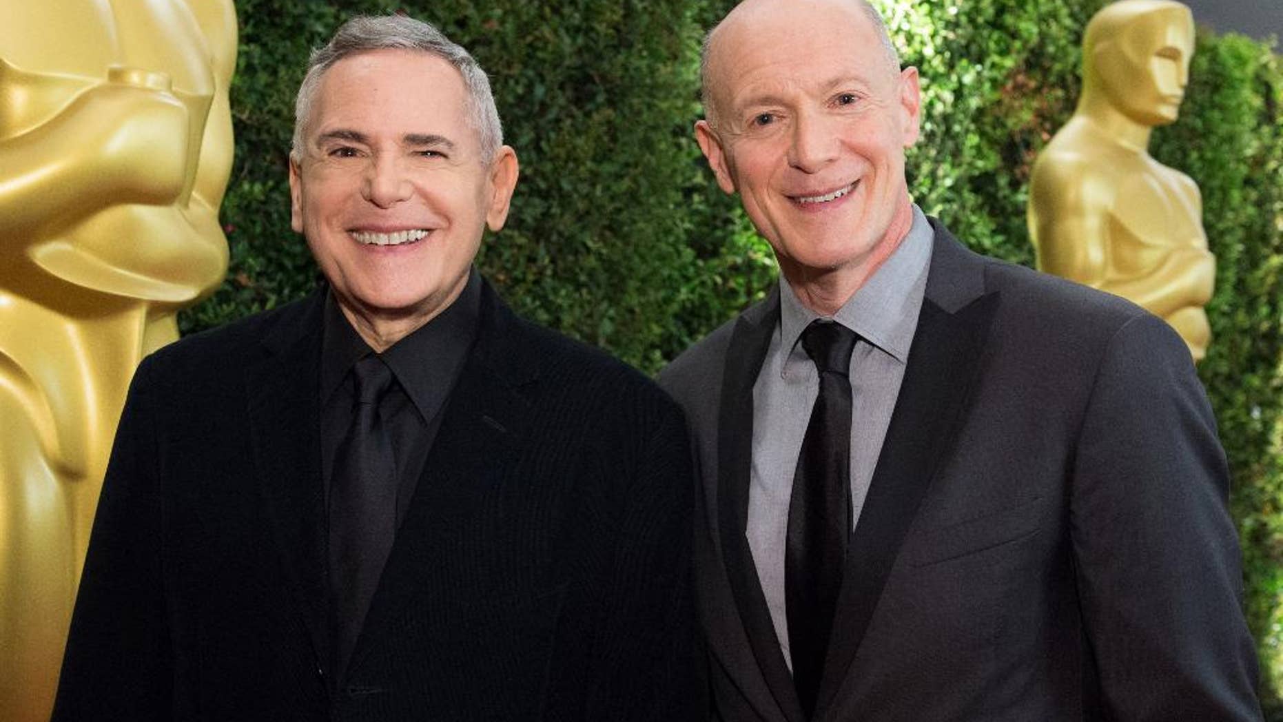 This Nov. 16, 2013 photo provided by courtesy of the Academy of Motion Picture Arts and Sciences shows producers Craig Zadan, left, and Neil Meron attending the 2013 Governors Awards at The Ray Dolby Ballroom at Hollywood & Highland Center in Hollywood, Calif. The producers, Zadan and Meron, tell us what and what not to expect on this year’s Oscar show and how they’re keeping it fresh after three years on the job. The 87th annual Academy Awards are presented on Sunday, Feb. 22, 2015, in Los Angeles. (AP Photo/AMPAS, Richard Harbaugh)