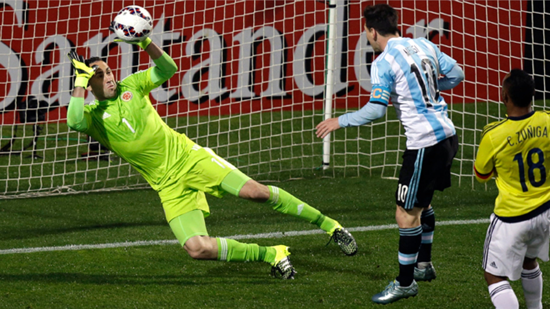 Colombia goalkeeper David Ospina stops a headshot by Argentina's Lionel Messi, center, during a Copa America quarterfinal soccer match at the Sausalito Stadium in Vina del Mar, Chile, Friday, June 26, 2015. (AP Photo/Jorge Saenz)