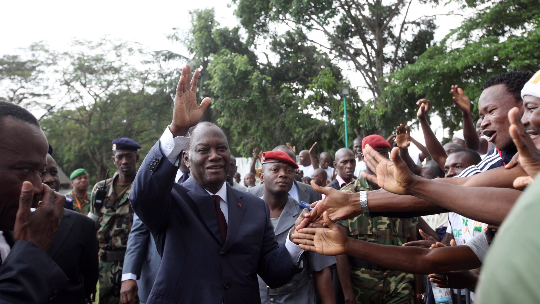 Dec. 30, 2010: Alassane Ouattara, centre, opposition leader greet his supporters in Abidjan, Ivory Coast. Ouattara is widely regarded as being the winner of recent presidential elections, although incumbent leader Laurent Gbagbo refuses to relinquish power. The United Nations accused Gbagbo's security forces of blocking access to sites thought to hide the bodies of up to 80 victims amidst reports that political opponents were abducted by security forces loyal to Gbagbo after the disputed election.