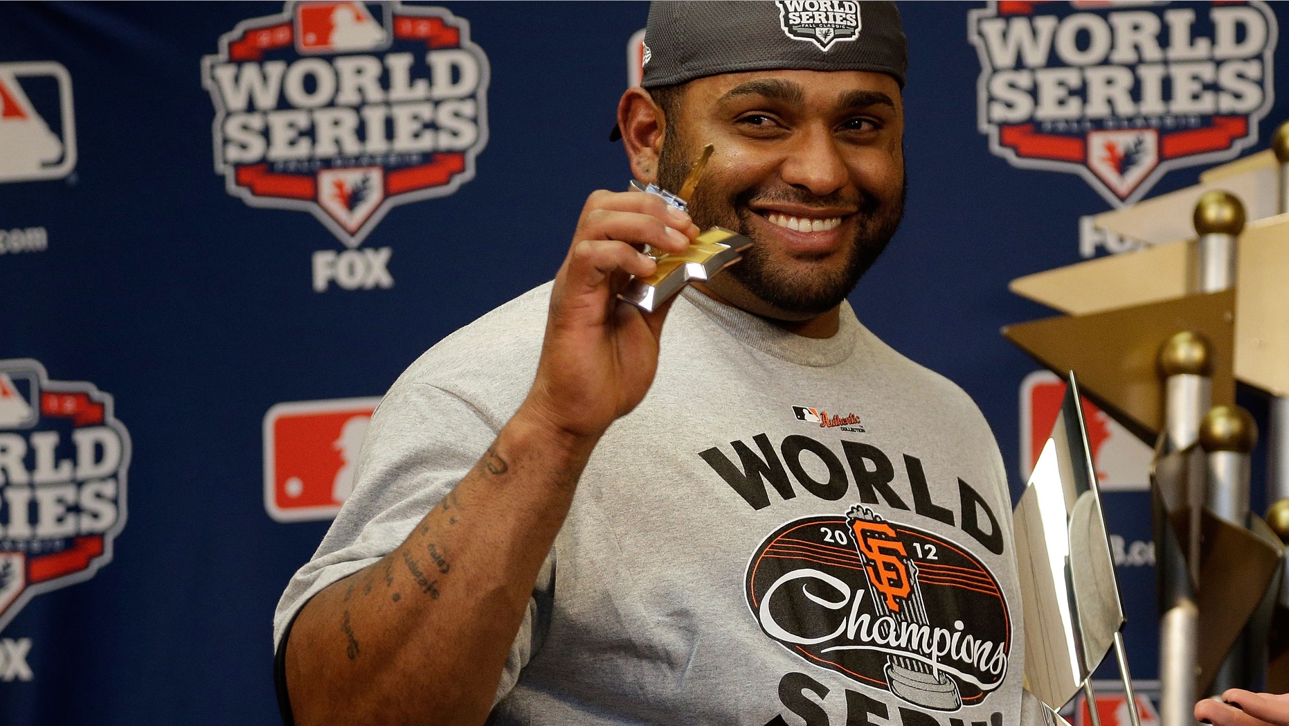 Pablo Sandoval #48 of the San Francisco Giants poses with the Most Valuable Player Trophy after Game Four of the Major League Baseball World Series at Comerica Park on October 28, 2012 in Detroit, Michigan.
