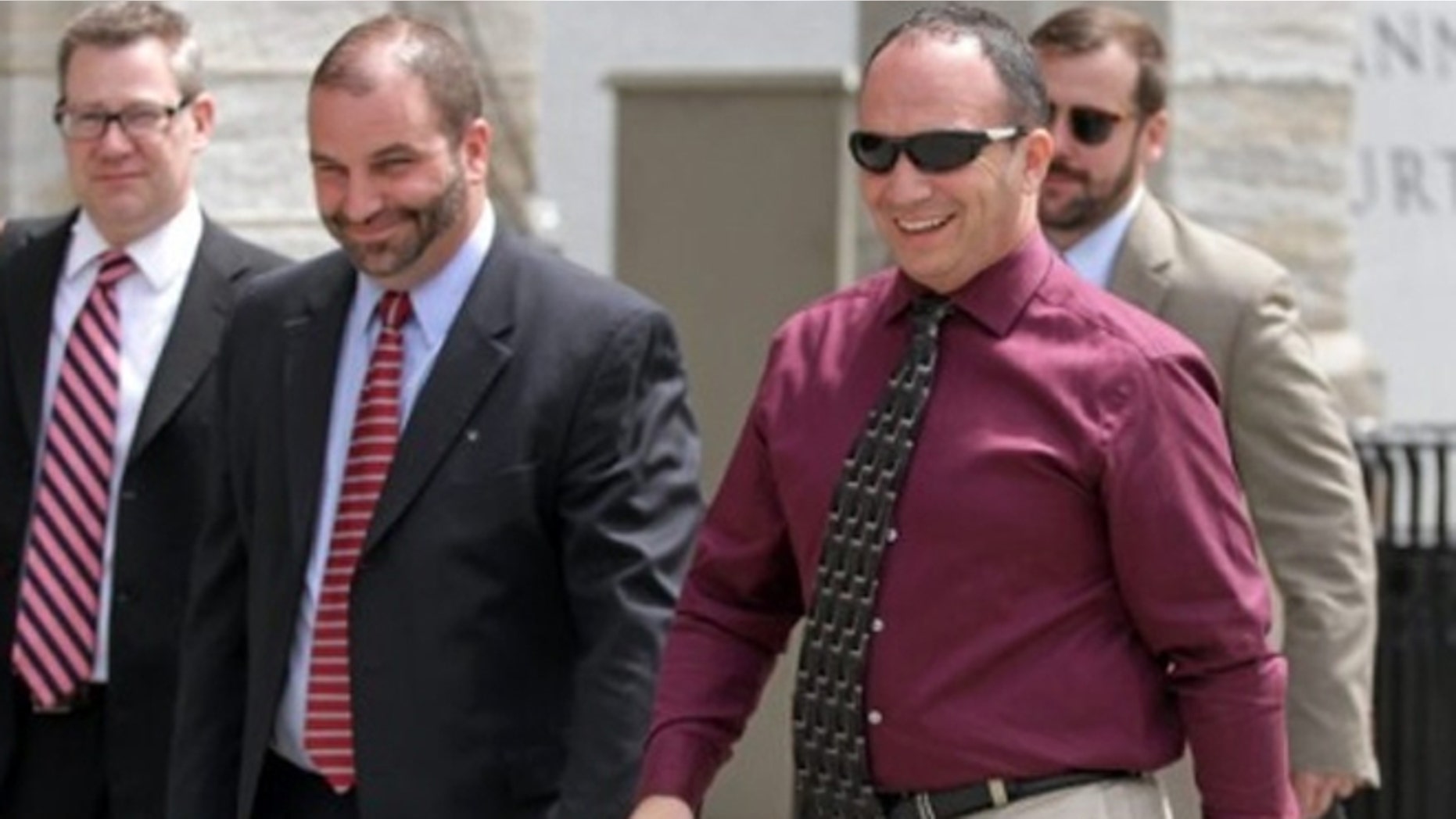 Former Scott Twp. Police Chief James Romano, right, leaves the Lackawanna County Courthouse on Monday.