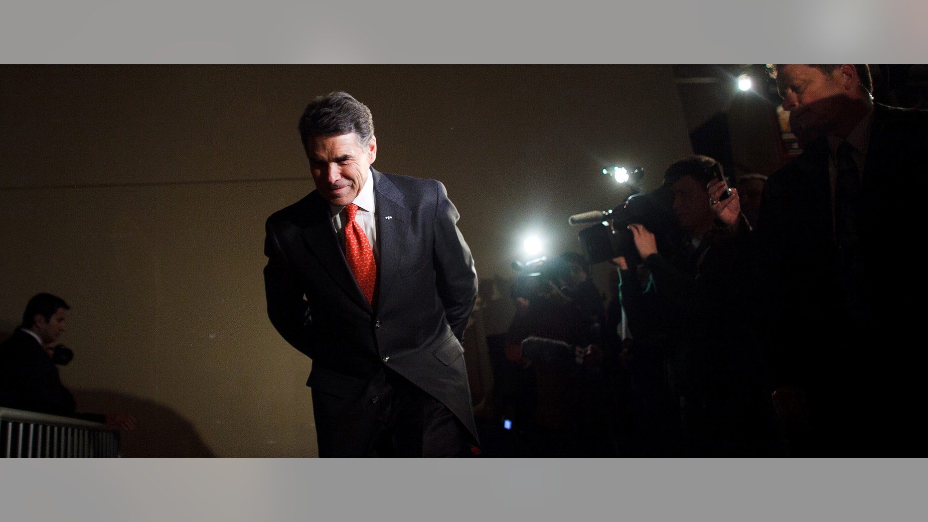 WEST DES MOINES, IA - JANUARY 3: Republican presidential candidate, Texas Gov. Rick Perry prepares to speak with voters attending the West Des Moines Precinct 1 and 2 GOP Caucus held at the Seven Flags Event Center January 3, 2012 in West Des Moines, Iowa. After months of campaigning by candidates, Iowan voters throughout the state prepare to participate in the first caucus of the 2012 presidential election. (Photo by Jonathan Gibby/Getty Images)