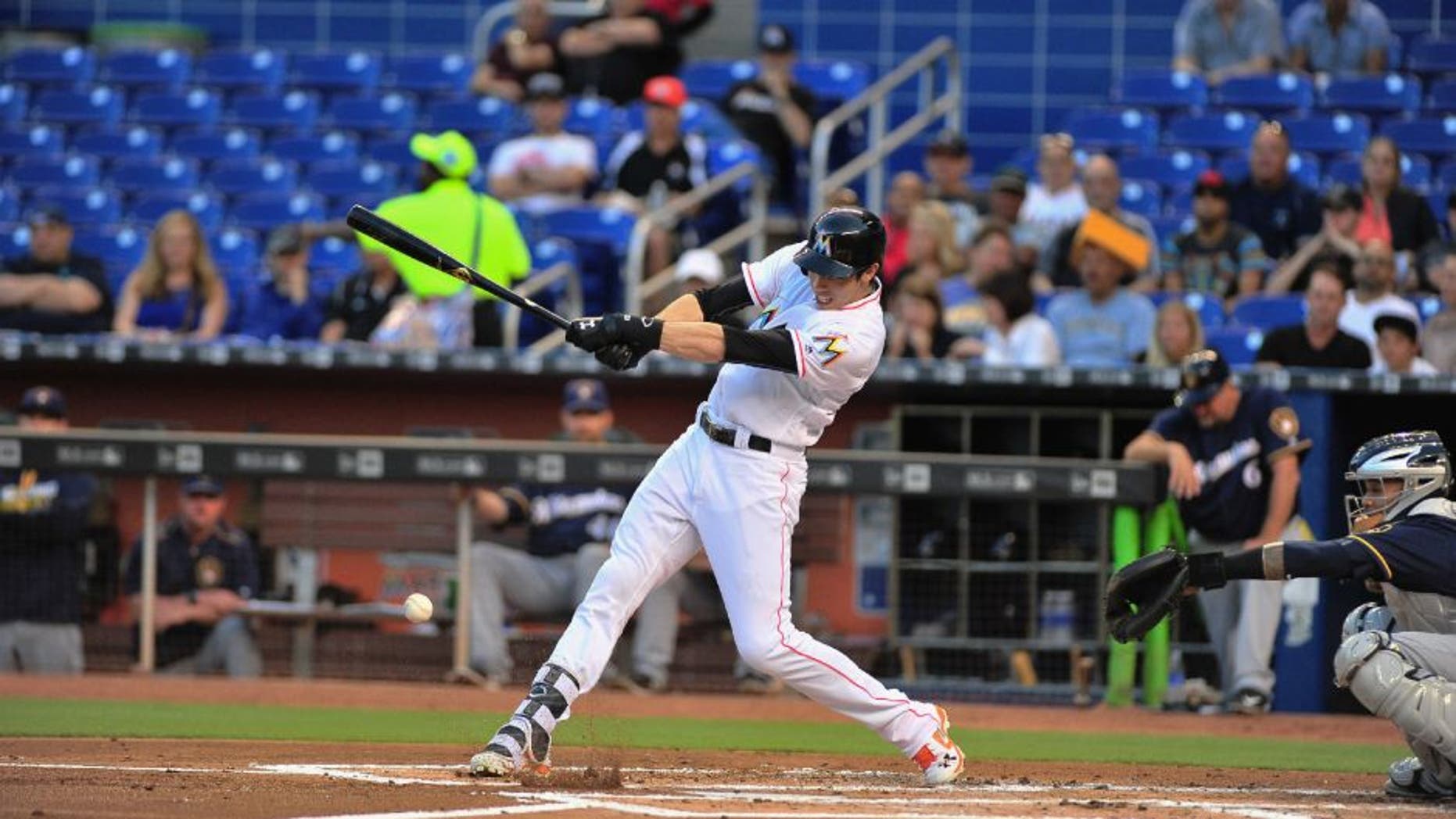 Miami Marlins left fielder Christian Yelich flies out during the first inning of a baseball game against the Milwaukee Brewers.