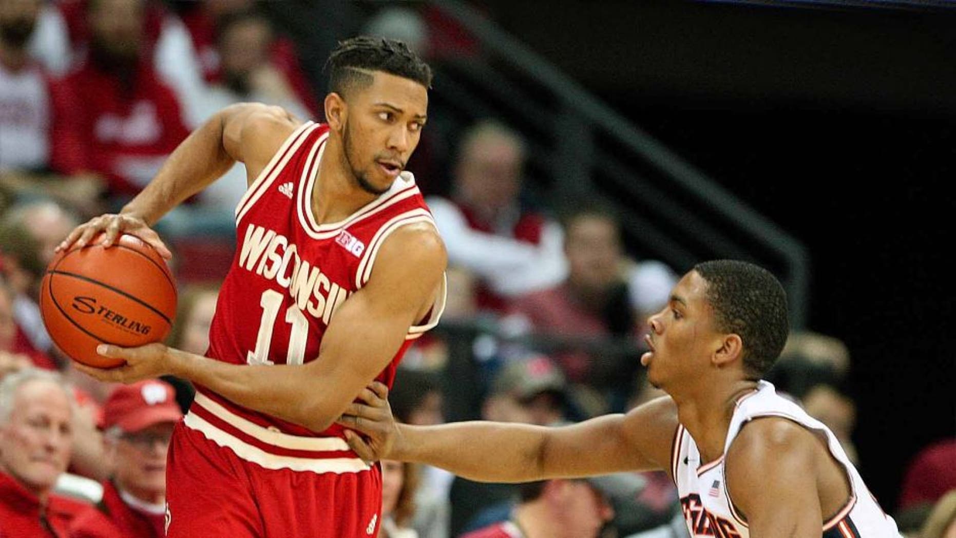 Wisconsin Badgers guard Jordan Hill looks to pass as Illinois guard Malcolm Hill defends during the first half at the Kohl Center in Madison, Wis., on Sunday, Feb. 21, 2016.