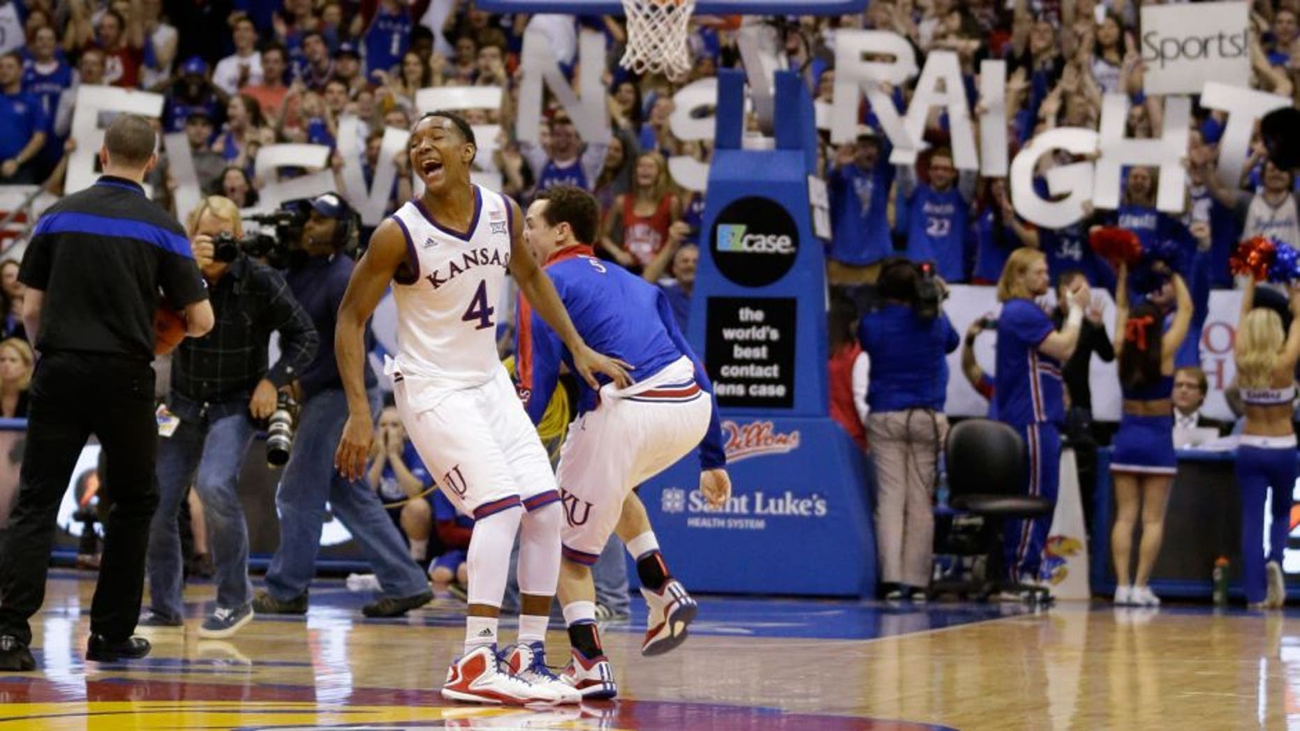 Kansas guard Devonte Graham (4) celebrates following an NCAA college basketball game against West Virginia at Allen Fieldhouse in Lawrence, Kan., Tuesday, March 3, 2015. Kansas defeated West Virginia 76-69 in overtime. Kansas claimed its 11th consecutive Big 12 rchampionship. (AP Photo/Orlin Wagner)