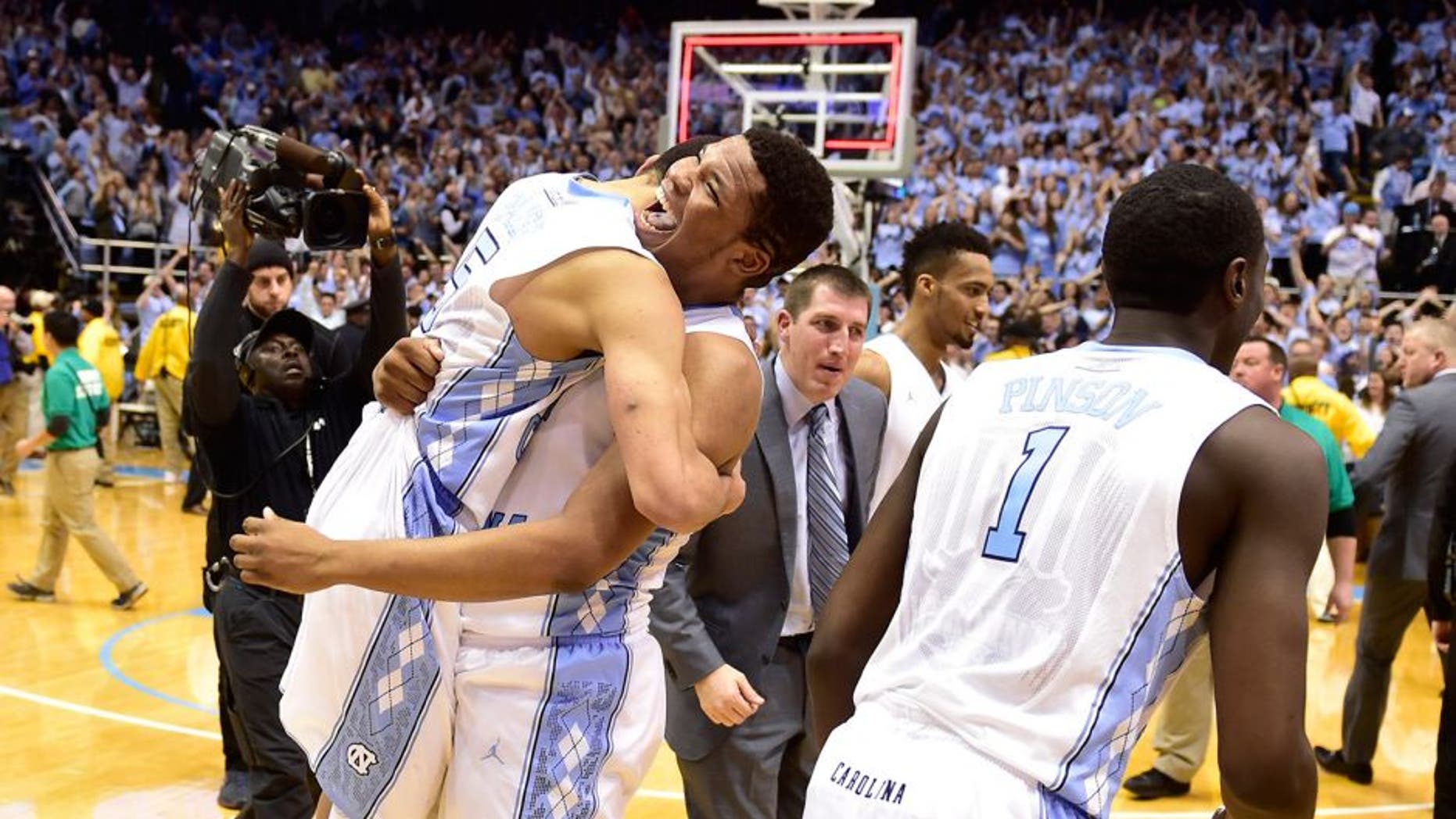 Jan 10, 2015; Chapel Hill, NC, USA; North Carolina Tar Heels guard/forward Theo Pinson (1) and guard Marcus Paige (5) and forward Kennedy Meeks (3) react after the game. The Tar Heels defeated the Cardinals 72-71 at Dean E. Smith Center. Mandatory Credit: Bob Donnan-USA TODAY Sports