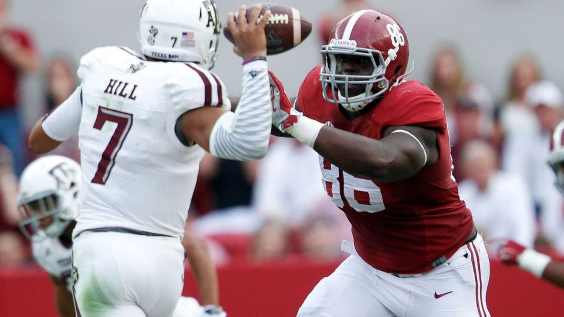 Oct 18, 2014; Tuscaloosa, AL, USA; Alabama Crimson Tide defensive lineman A'Shawn Robinson (86) puts the pressure on Texas A&M Aggies quarterback Kenny Hill (7) at Bryant-Denny Stadium. The Crimson Tide defeated the Aggies 59-0. Mandatory Credit: Marvin Gentry-USA TODAY Sports