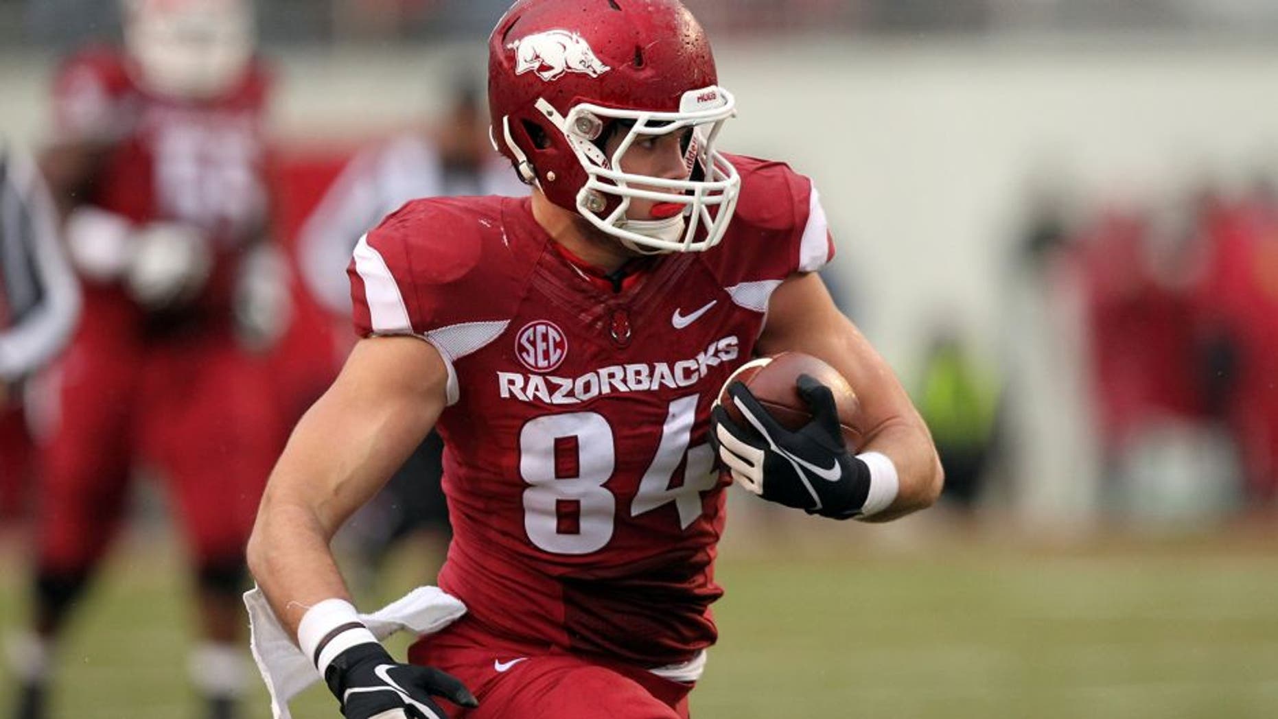 Nov 22, 2014; Fayetteville, AR, USA; Arkansas Razorbacks tight end Hunter Henry (84) runs after a catch in the first half against the Ole Miss Rebels at Donald W. Reynolds Razorback Stadium. Mandatory Credit: Nelson Chenault-USA TODAY Sports