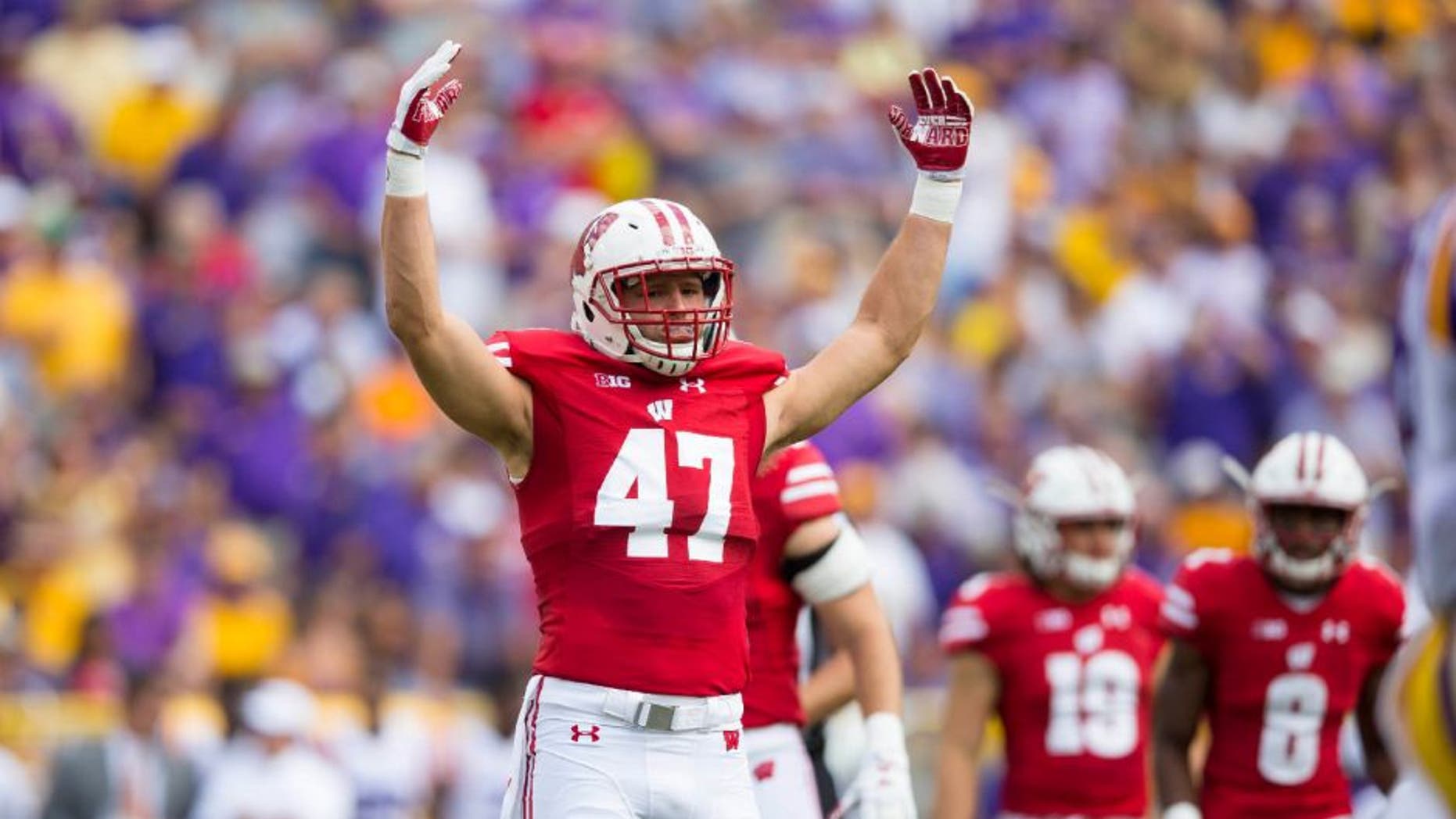 Wisconsin Badgers linebacker Vince Biegel fires up the crowd during the first quarter against the LSU Tigers at Lambeau Field.