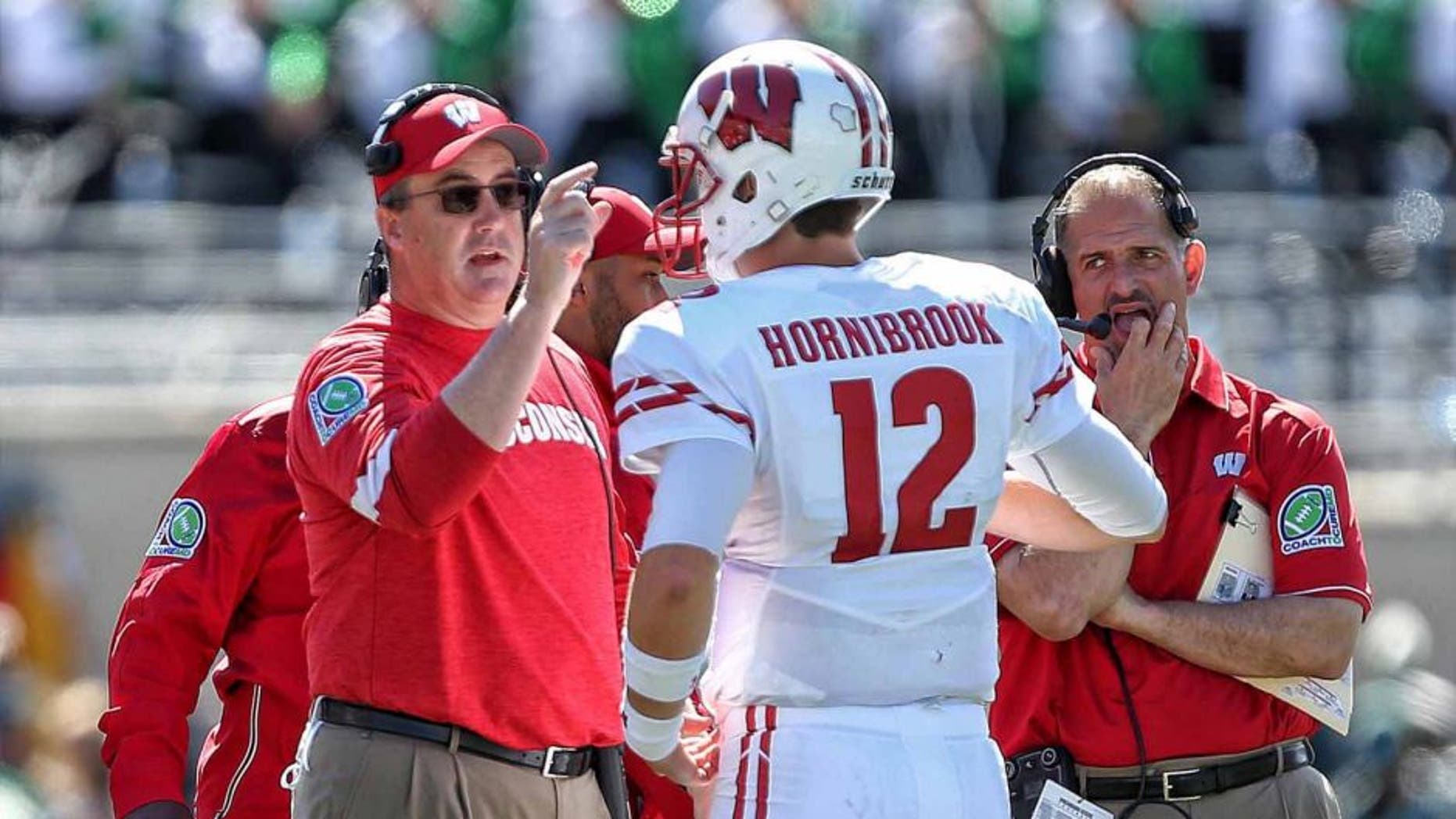 Wisconsin Badgers head coach Paul Chryst talks to quarterback Alex Hornibrook during a time out during the first half of a game against the Michigan State Spartans at Spartan Stadium in East Lansing, Mich., on Sept. 24, 2016.