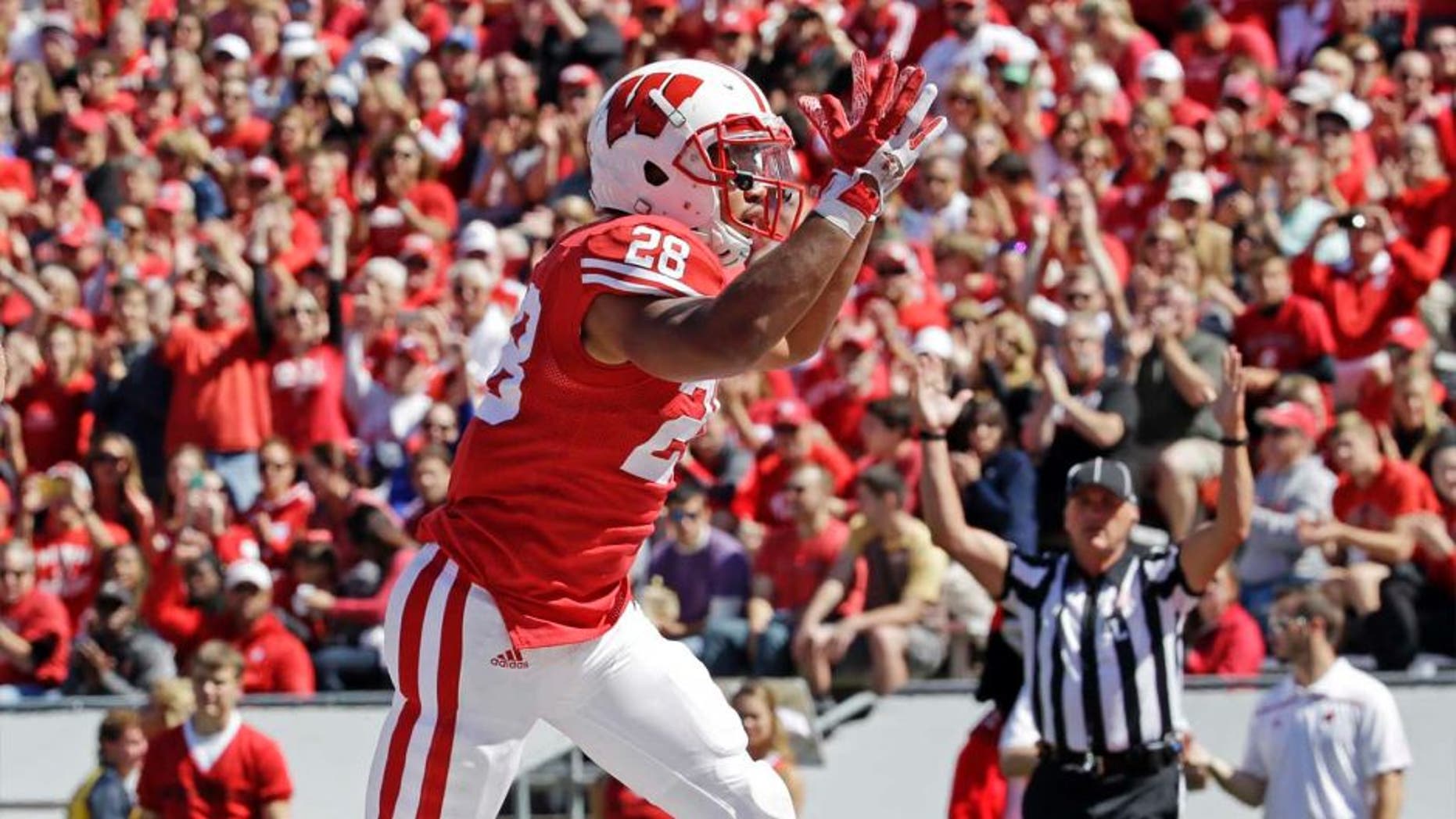 Wisconsin's Taiwan Deal celebrates a touchdown run during the first half of an NCAA college football game against Miami of Ohio, Saturday, Sept. 12, 2015, in Madison, Wis.