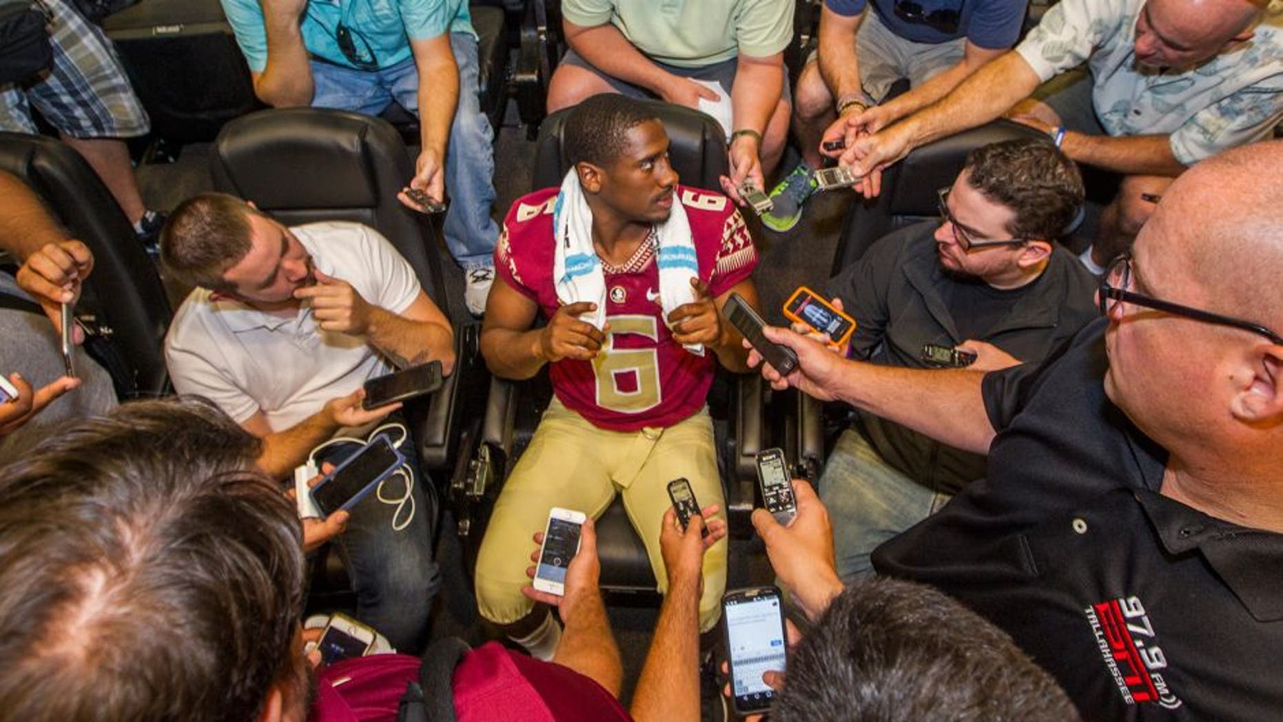 Florida State quarterback Everett Golson, center, talks during NCAA college football media day in Tallahassee, Fla., Sunday, Aug. 9, 2015. (AP Photo/Mark Wallheiser)