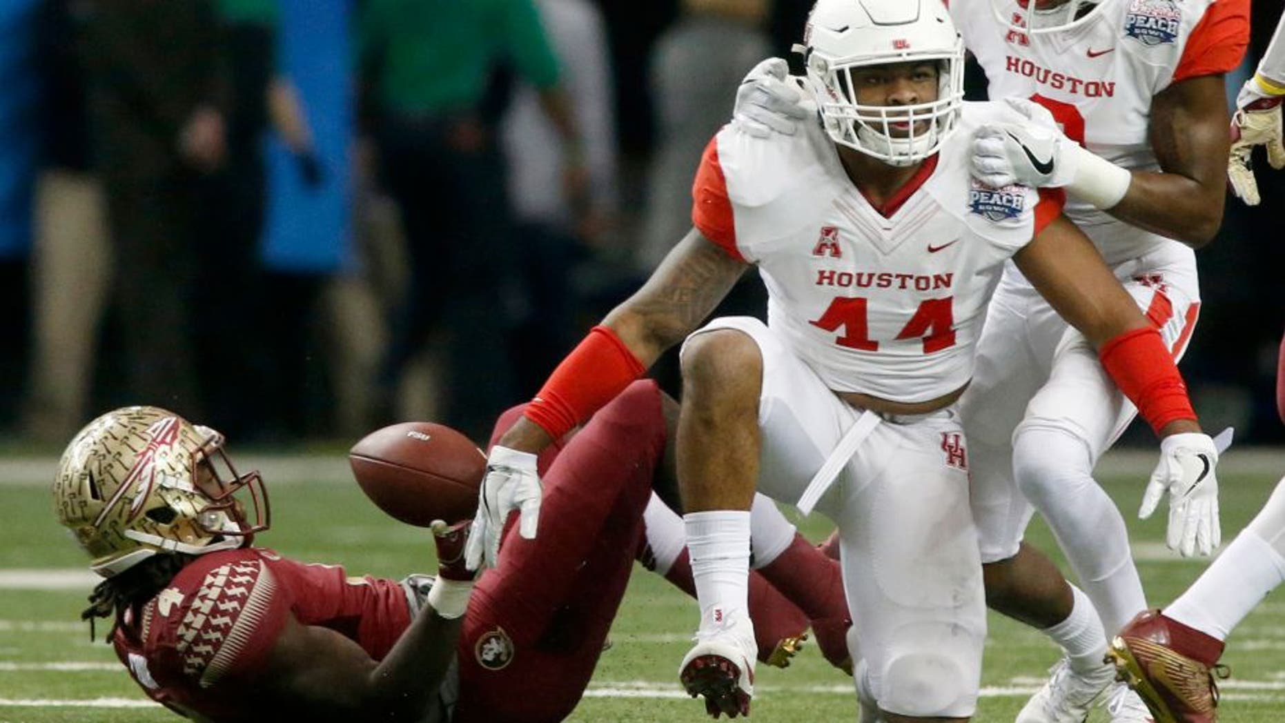 Dec 31, 2015; Atlanta, GA, USA; Houston Cougars linebacker Elandon Roberts (44) celebrates with cornerback William Jackson III (3) after a tackle against Florida State Seminoles running back Dalvin Cook (4) in the first quarter of the 2015 Chick-fil-A Peach Bowl at the Georgia Dome. Mandatory Credit: Jason Getz-USA TODAY Sports