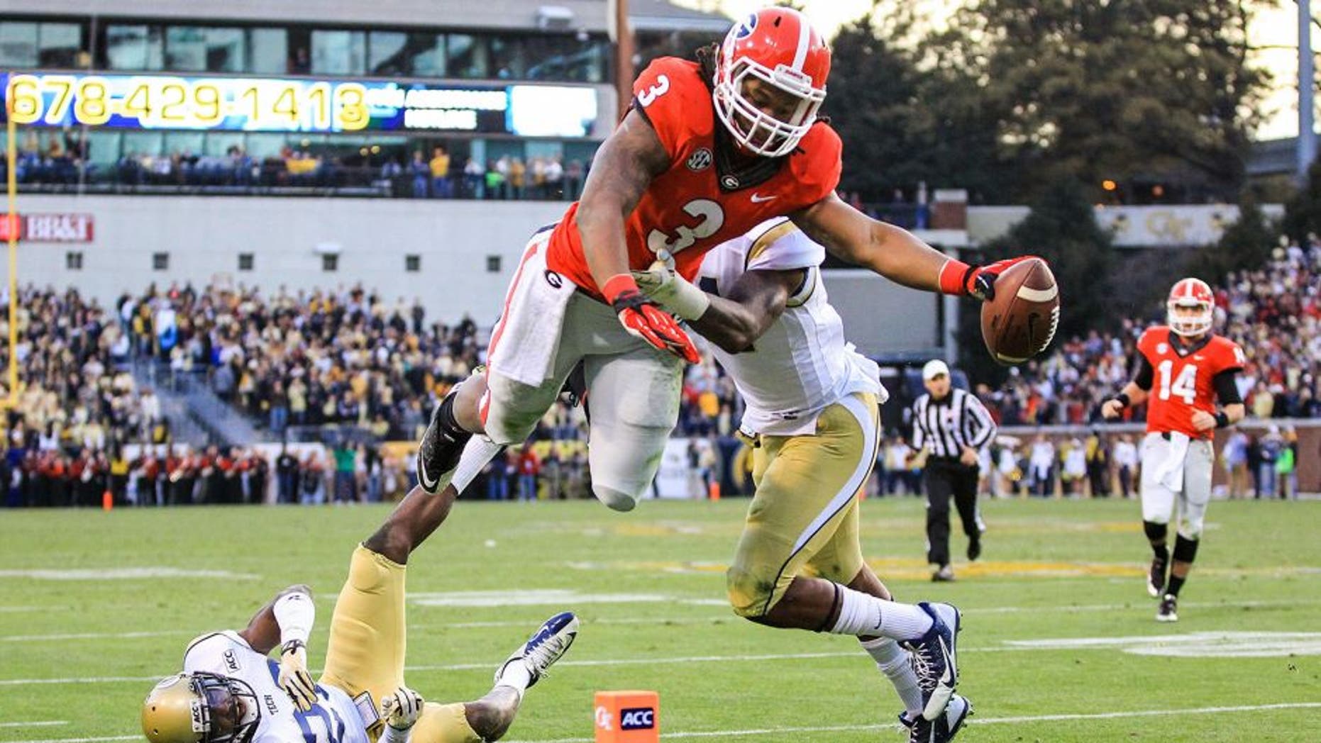Nov 30, 2013; Atlanta, GA, USA; Georgia Bulldogs running back Todd Gurley (3) dives into the end zone for a touchdown over Georgia Tech Yellow Jackets cornerback D.J. White (28) and linebacker Brandon Watts (11) in the first half at Bobby Dodd Stadium. Mandatory Credit: Daniel Shirey-USA TODAY Sports