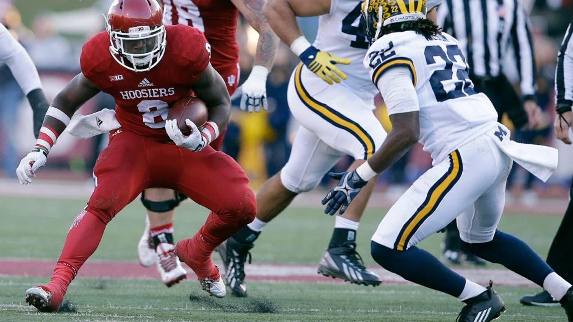 Indiana's Jordan Howard (8) runs against Michigan's Jarrod Wilson (22) during the first half of an NCAA college football game Saturday, Nov. 14, 2015, in Bloomington, Ind. (AP Photo/Darron Cummings)