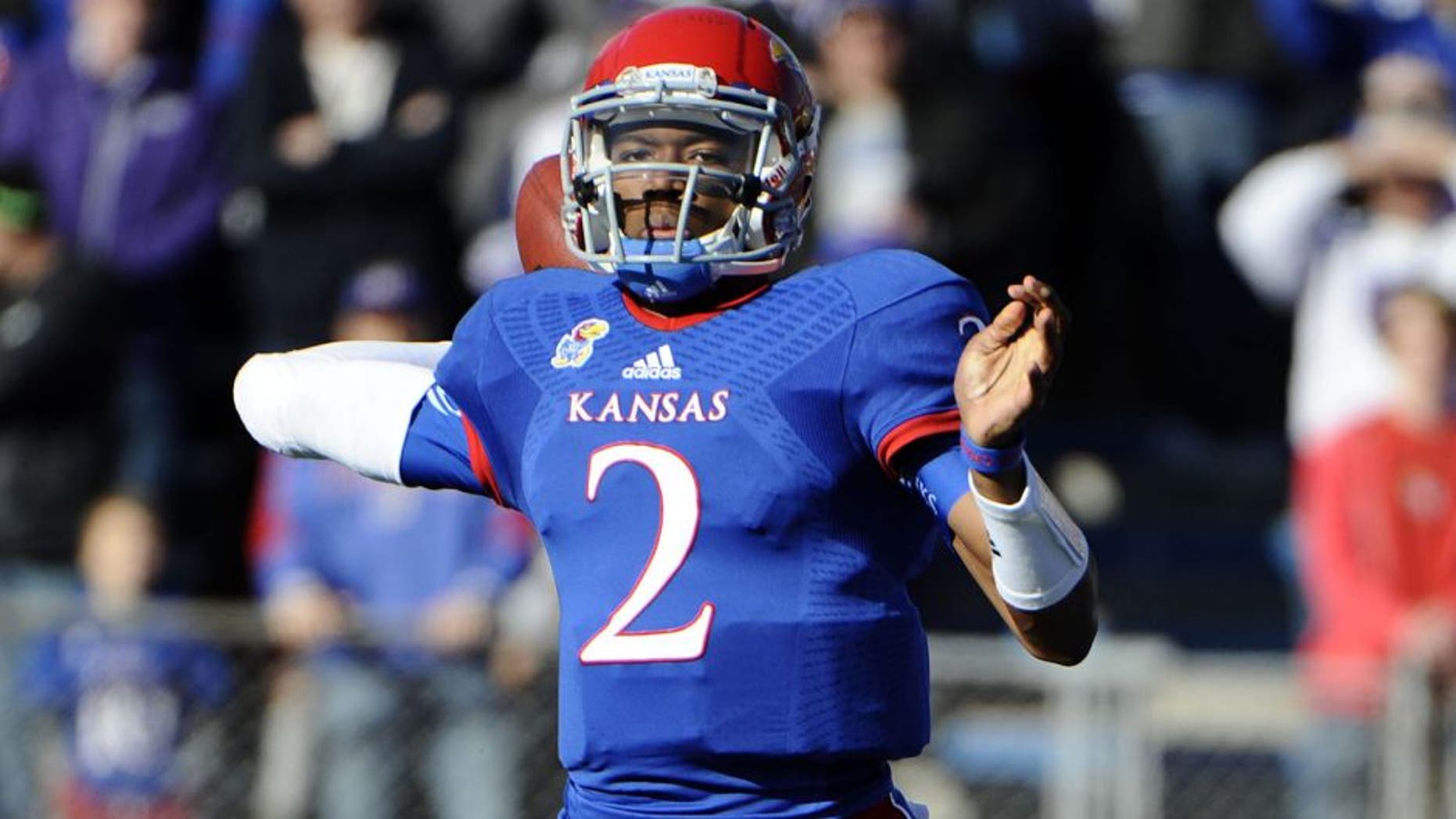 Nov 30, 2013; Lawrence, KS, USA; Kansas Jayhawks quarterback Montell Cozart (2) throws a pass against the Kansas State Wildcats in the first half at Memorial Stadium. Mandatory Credit: John Rieger-USA TODAY Sports