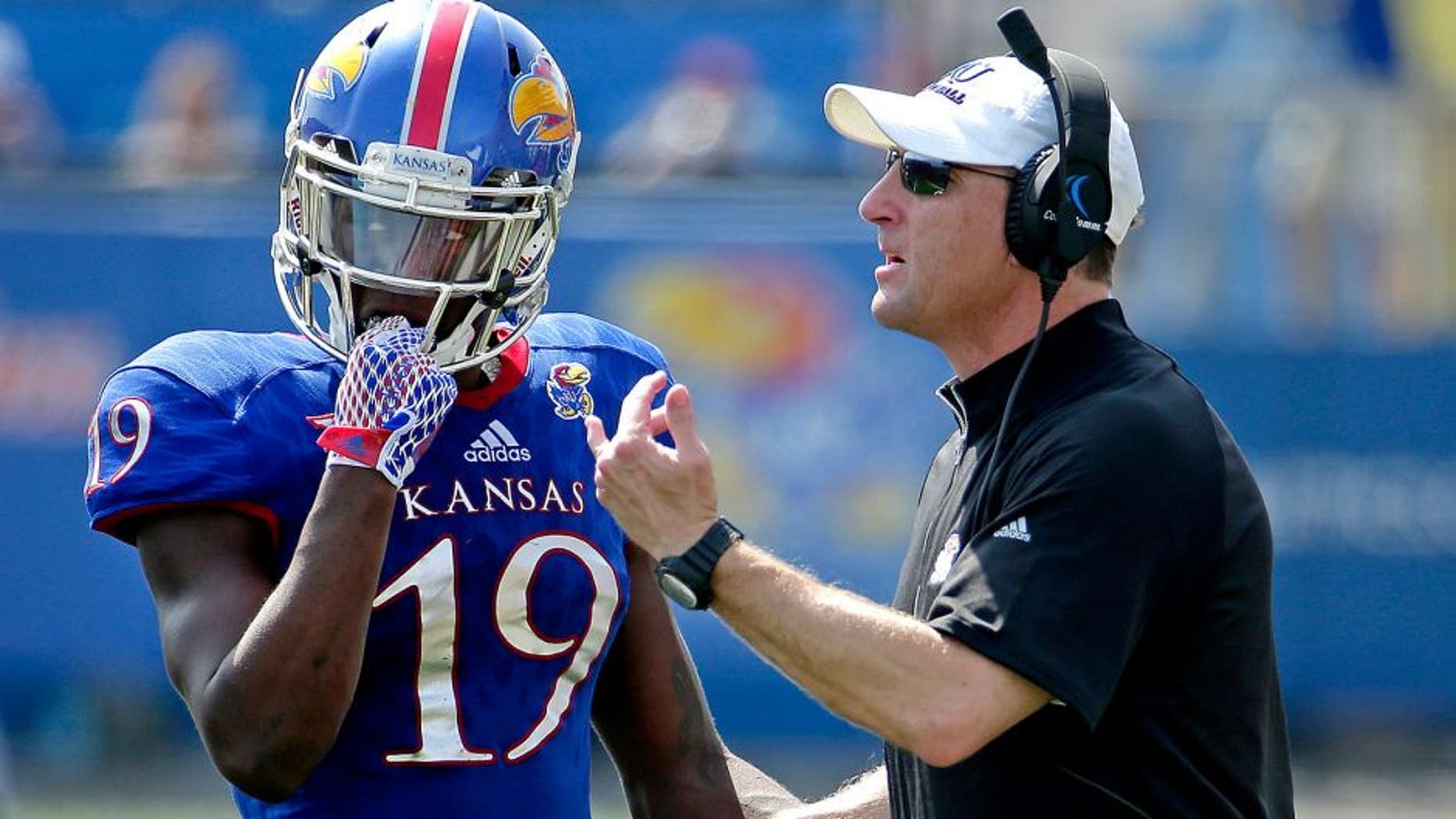 Kansas head coach David Beaty talks to Kansas cornerback Tyrone Miller Jr. during the first half of an NCAA football game against South Dakota State Saturday, Sept. 5, 2015, in Lawrence, Kan. (AP Photo/Charlie Riedel)