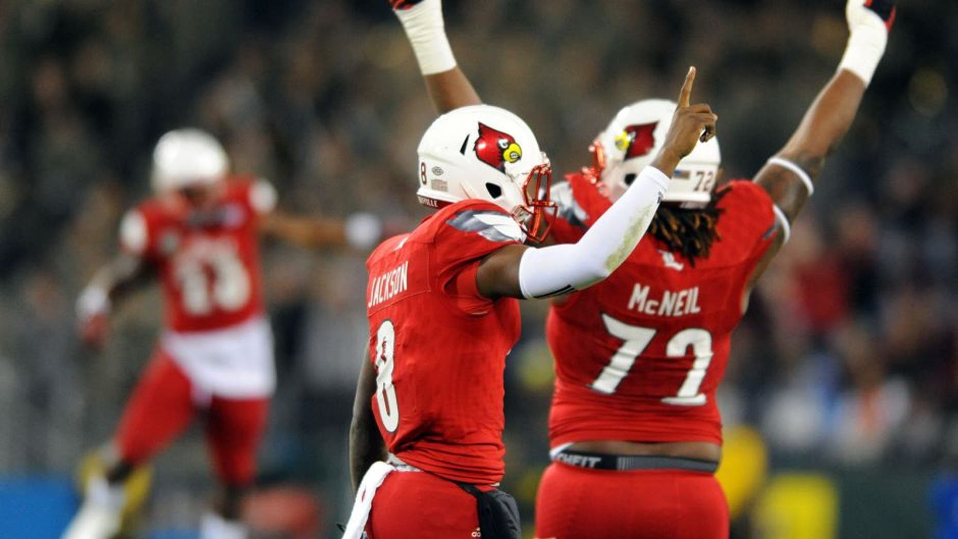 Dec 30, 2015; Nashville, TN, USA; Louisville Cardinals quarterback Lamar Jackson (8) celebrates after a 62-yard touchdown run during the first half against the Texas A&M Aggies in the 2015 Music City Bowl at Nissan Stadium. Mandatory Credit: Christopher Hanewinckel-USA TODAY Sports