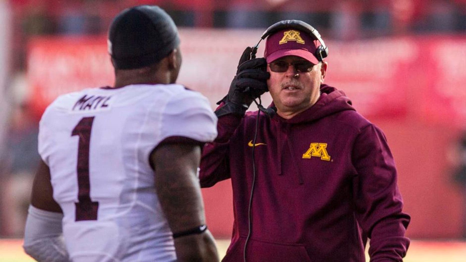 Minnesota Golden Gophers head coach Jerry Kill (right) talks to receiver KJ Maye during the second half of Minnesota's 28-24 win against the Nebraska Cornhuskers.