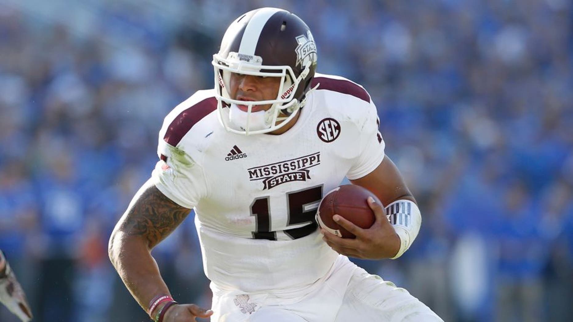 Oct 25, 2014; Lexington, KY, USA; Mississippi State Bulldogs quarterback Dak Prescott (15) runs the ball against the Kentucky Wildcats at Commonwealth Stadium. Mandatory Credit: Mark Zerof-USA TODAY Sports