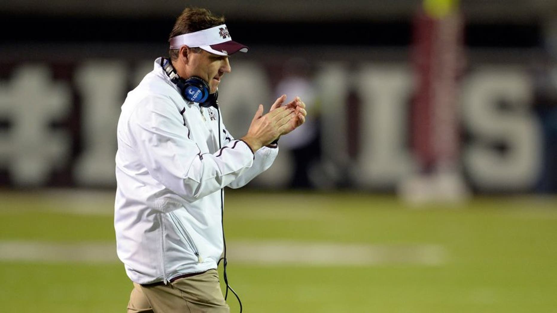 Nov 16, 2013; Starkville, MS, USA; Mississippi State Bulldogs head coach Dan Mullen cheers on hs players following a series of downs against the Alabama Crimson Tide during the first quarter at Davis Wade Stadium. Mandatory Credit: John David Mercer-USA TODAY Sports