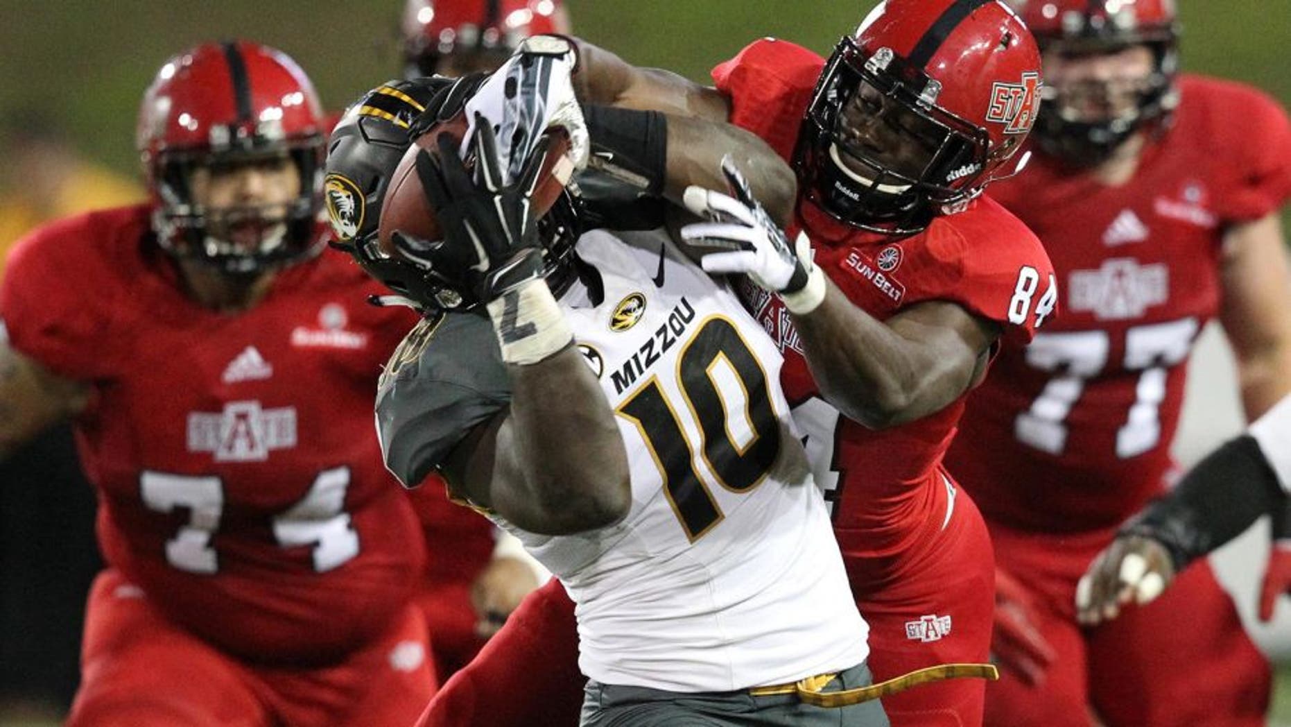 Sep 12, 2015; Jonesboro, AR, USA; Arkansas State Red Wolves wide receiver Dijon Pachal (84) fights for the ball as Missouri Tigers linebacker Kentrell Brothers (10) strips it for an interception in the fourth quarter at ASU Stadium. Missouri defeated Arkansas State 27-20. Mandatory Credit: Nelson Chenault-USA TODAY Sports
