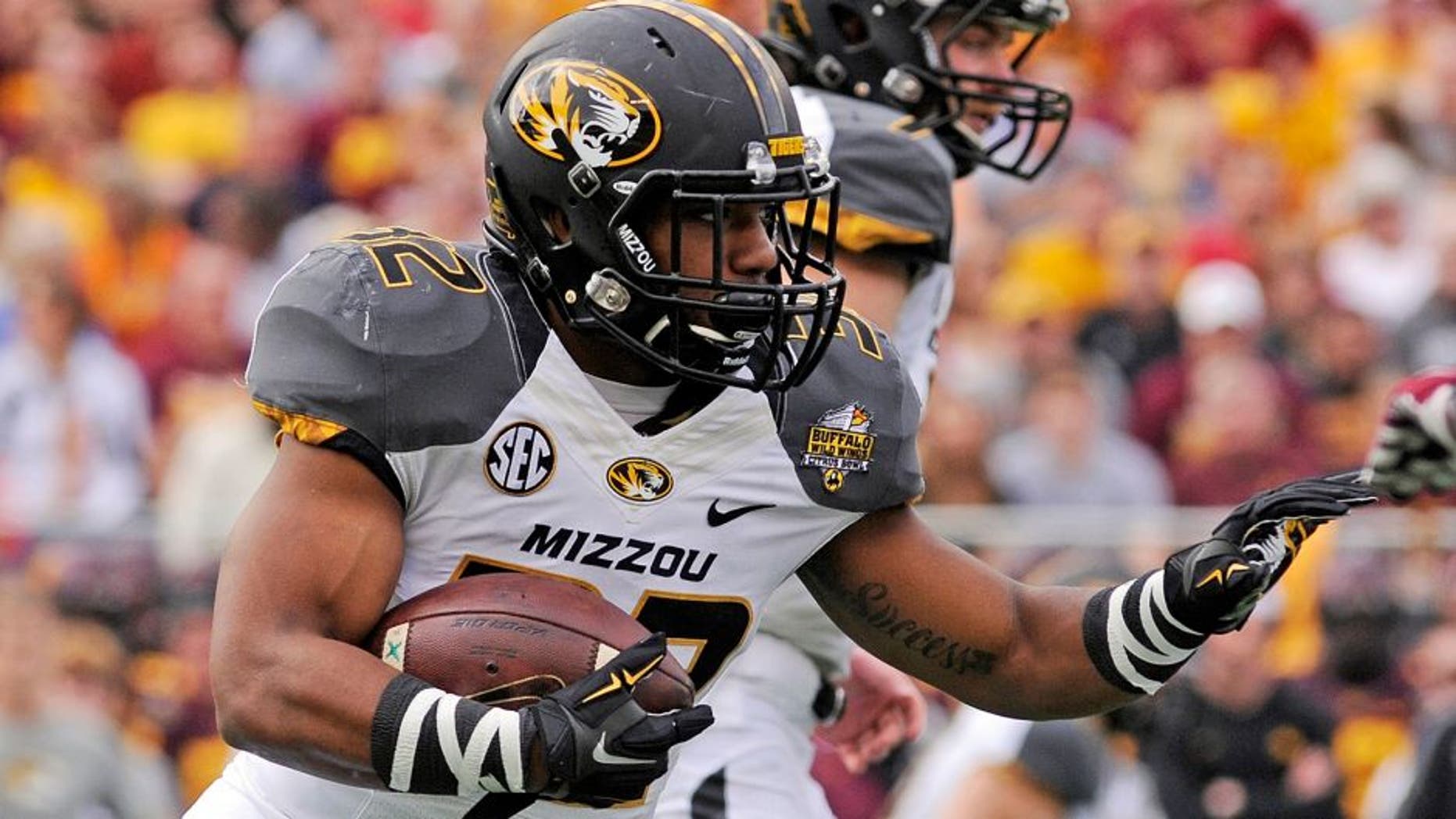 Jan 1, 2015; Orlando, FL, USA; Missouri Tigers running back Russell Hansbrough (32) runs the ball against the Minnesota Golden Gophers in the first quarter of the 2015 Citrus Bowl at Florida Citrus Bowl. Mandatory Credit: David Manning-USA TODAY Sports