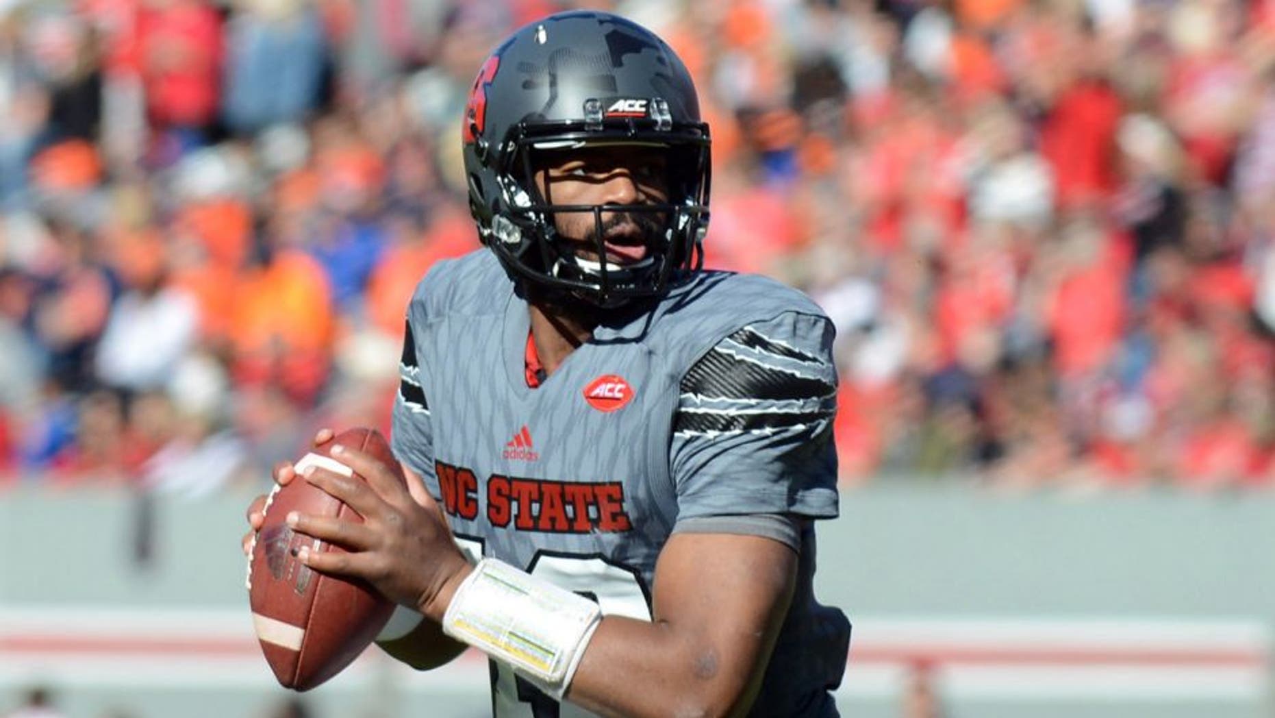 Nov 21, 2015; Raleigh, NC, USA; North Carolina State Wolfpack quarterback Jacoby Brissett (12) looks to pass during the first half against the Syracuse Orange at Carter Finley Stadium. Mandatory Credit: Rob Kinnan-USA TODAY Sports