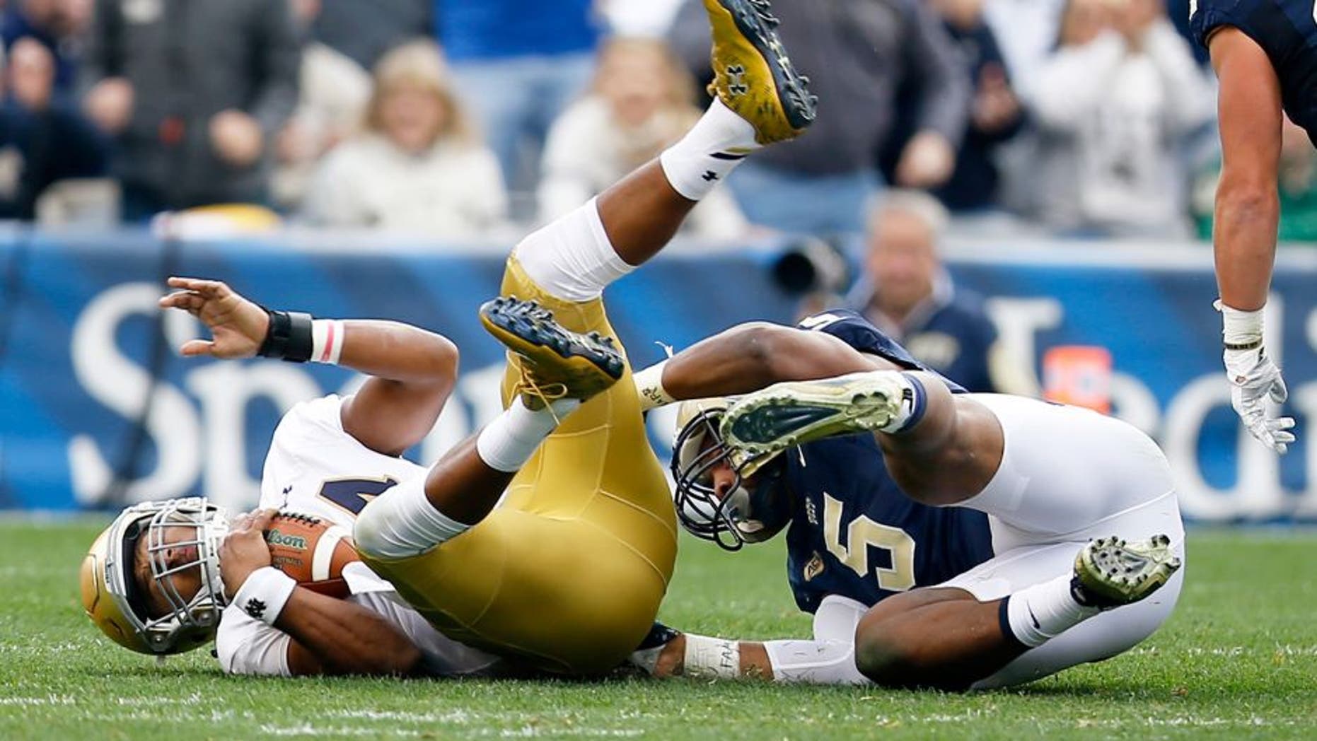 Notre Dame quarterback DeShone Kizer, left, is sacked by Pittsburgh defensive lineman Ejuan Price (5) in the first quarter of an NCAA football game, Saturday, Nov. 7, 2015, in Pittsburgh. (AP Photo/Keith Srakocic)