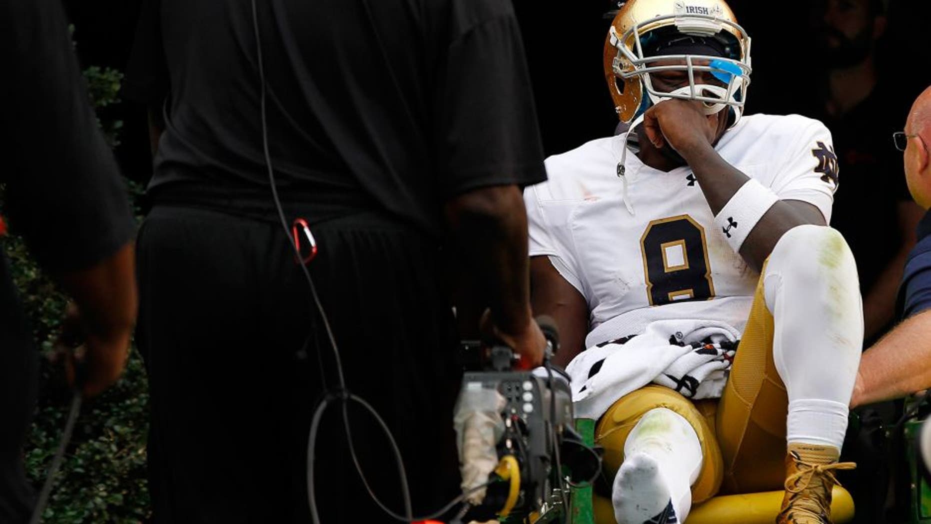 Sep 12, 2015; Charlottesville, VA, USA; Notre Dame Fighting Irish quarterback Malik Zaire (8) is carted off the field after injuring his right ankle against the Virginia Cavaliers in the third quarter at Scott Stadium. Mandatory Credit: Geoff Burke-USA TODAY Sports