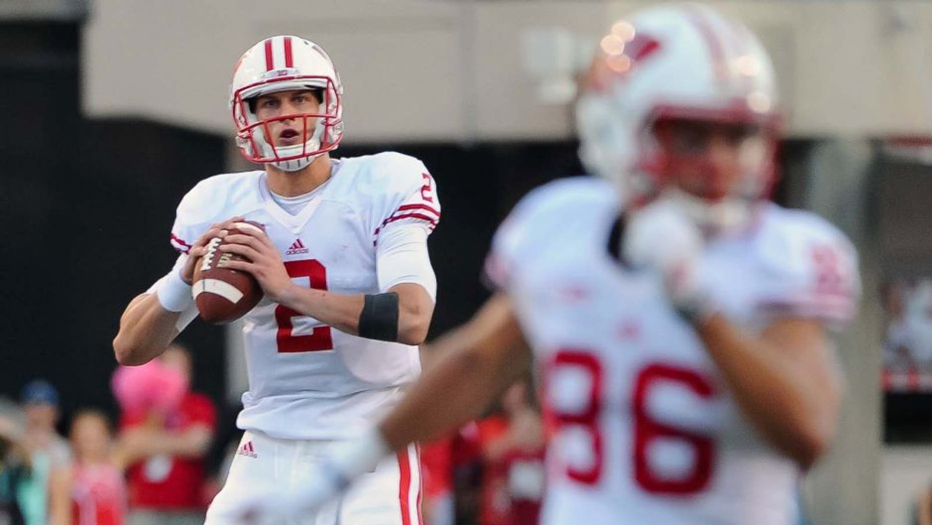 Wisconsin Badgers quarterback Joel Stave rolls out on the final drive of the game against the Nebraska Cornhuskers at Memorial Stadium in Lincoln, Neb., on Saturday, Oct. 10, 2015. Wisconsin won 23-21.