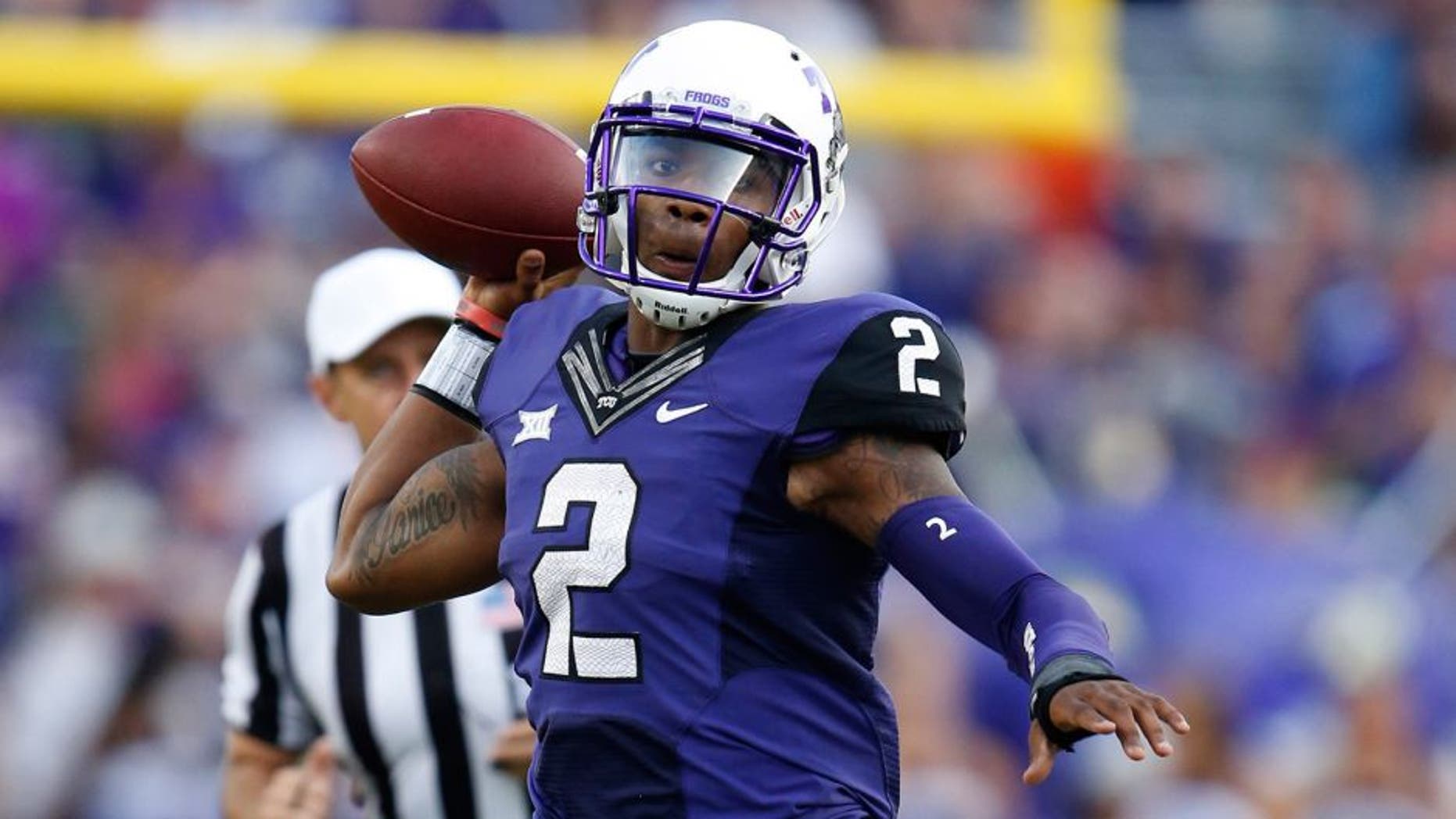 Oct 18, 2014; Fort Worth, TX, USA; TCU Horned Frogs quarterback Trevone Boykin (2) scrambles out of the pocket against the Oklahoma State Cowboys at Amon G. Carter Stadium. Mandatory Credit: Matthew Emmons-USA TODAY Sports