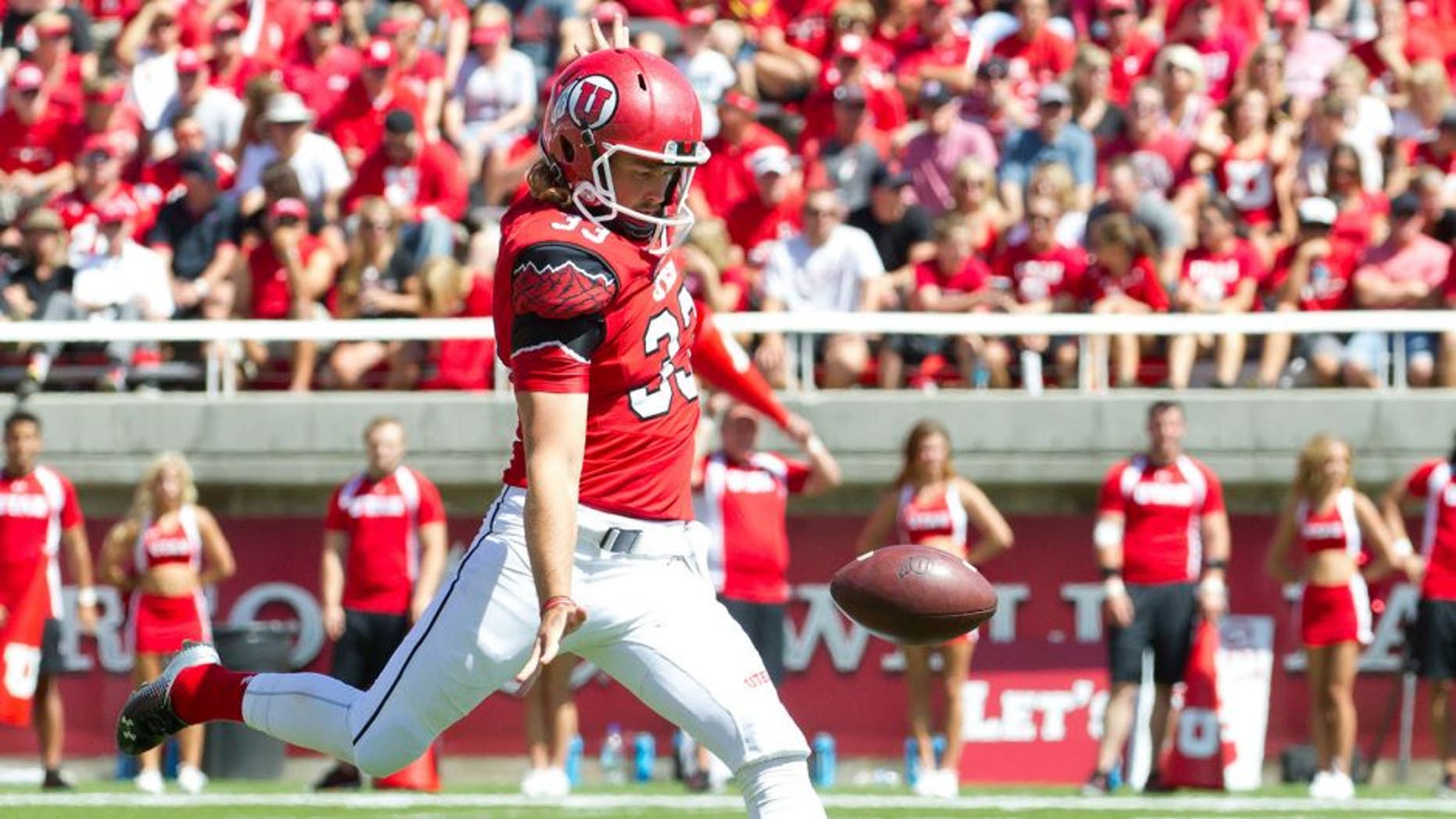 Sep 6, 2014; Salt Lake City, UT, USA; Utah Utes punter Tom Hackett (33) punts the ball during the first half against the Fresno State Bulldogs at Rice-Eccles Stadium. Utah won 59-27. Mandatory Credit: Russ Isabella-USA TODAY Sports
