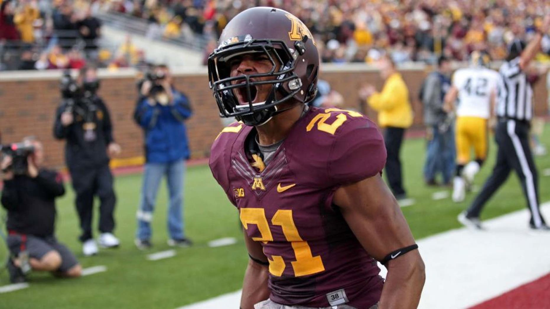 Sep 28, 2013; Minneapolis, MN, USA; Minnesota Golden Gophers defensive back Brock Vereen (21) celebrates after intercepting a pass in the second half against the Iowa Hawkeyes at TCF Bank Stadium. The Hawkeyes won 23-7. Mandatory Credit: Jesse Johnson-USA TODAY Sports