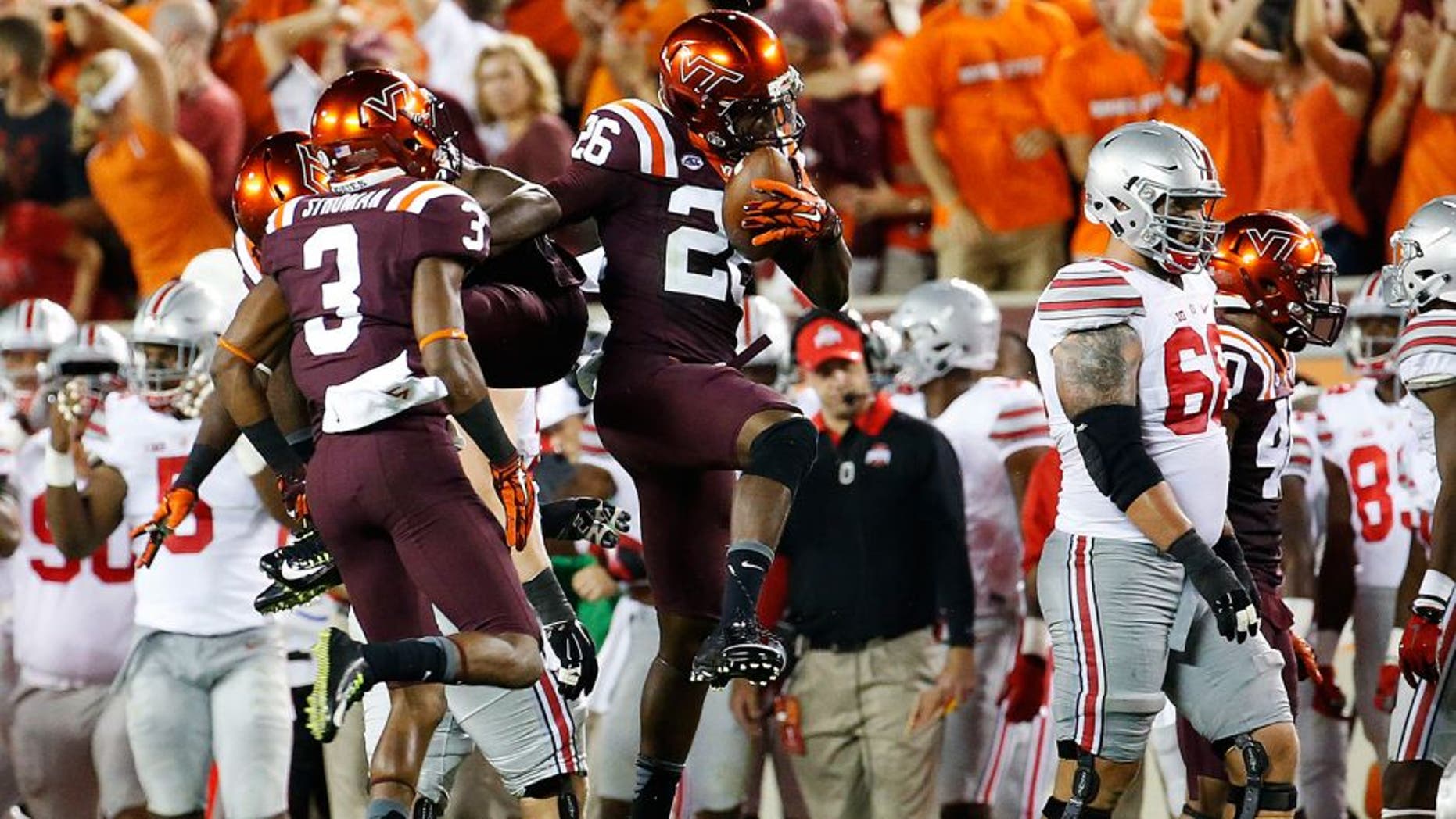 Sep 7, 2015; Blacksburg, VA, USA; Virginia Tech Hokies safety Desmond Frye (26) celebrates his interception during the second quarter against the Ohio State Buckeyes at Lane Stadium. Mandatory Credit: Peter Casey-USA TODAY Sports