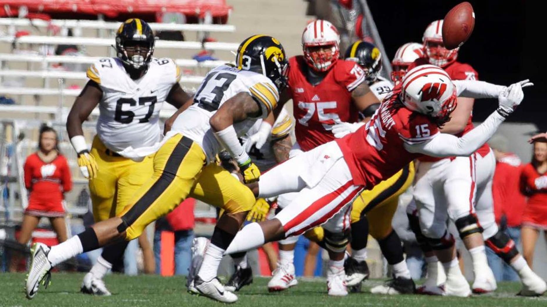 Wisconsin's Robert Wheelwright can't hang onto a pass in front of Iowa's Greg Mabin during the first half of an NCAA college football game in Madison, Wis., on Saturday, Oct. 3, 2015.