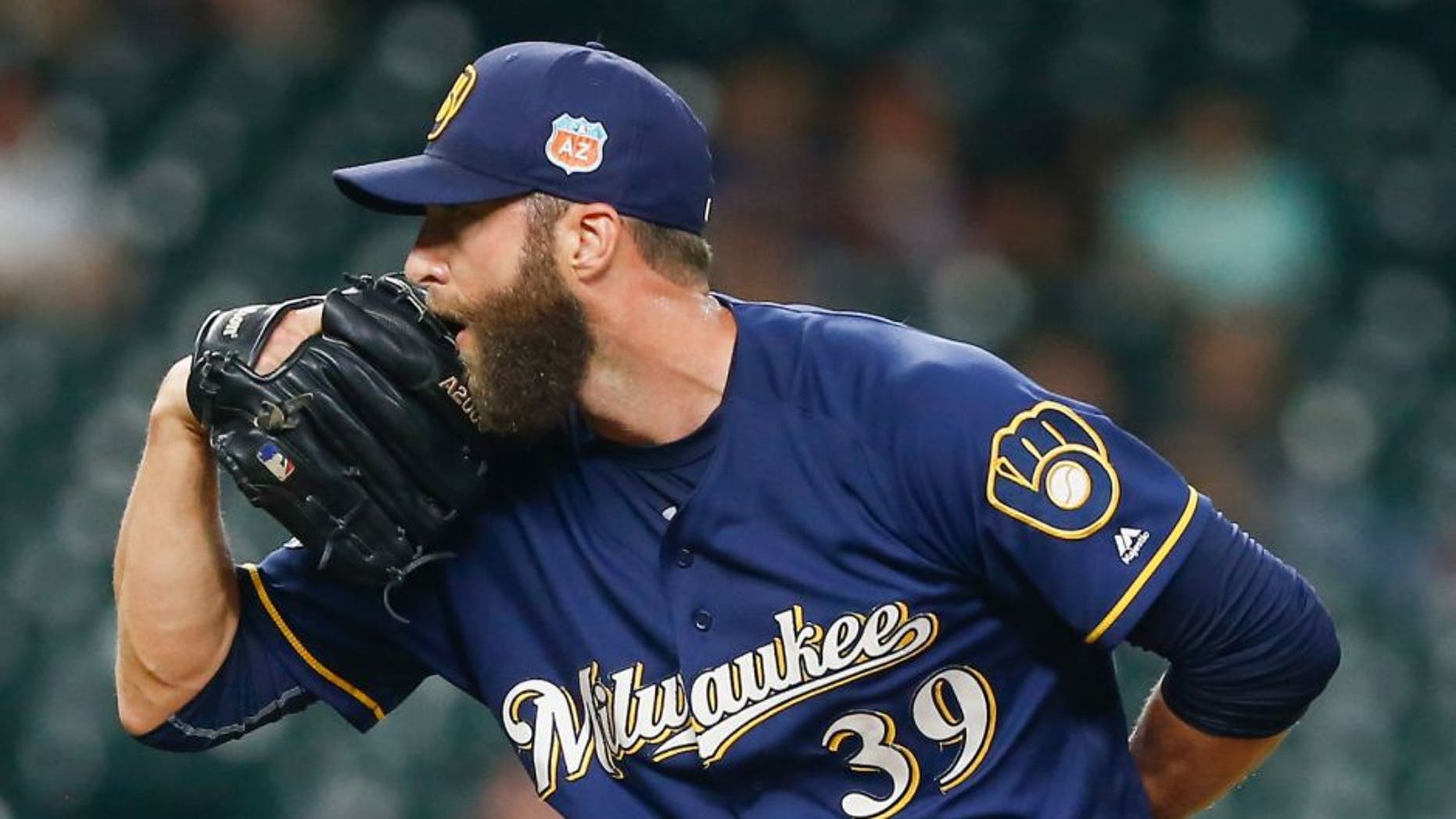 Milwaukee Brewers' Chris Capuano throws in the sixth inning against the Houston Astros during a spring training baseball game.