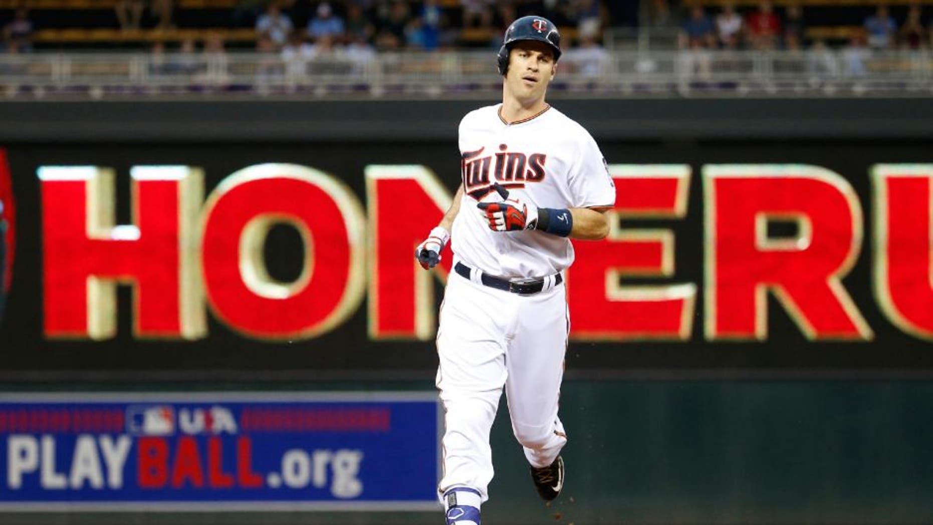 Minnesota Twins' Joe Mauer rounds the bases on his solo home run off Kansas City Royals starting pitcher Ian Kennedy.